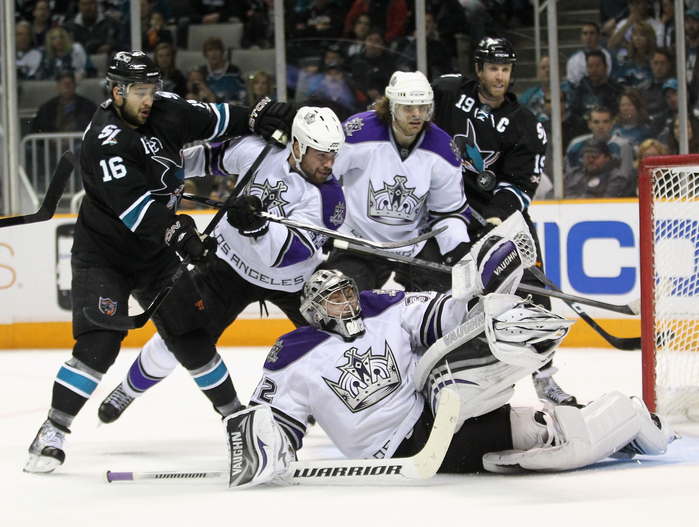 SAN JOSE, CA - APRIL 23:  Willie Mitchell #33 and Michal Handzus #26 of the Los Angeles Kings and Devin Setoguchi #16 and Joe Thornton #19 of the San Jose Sharks look on against the San Jose Sharks Jonathan Quick #32 of the Los Angeles Kings makes a divin