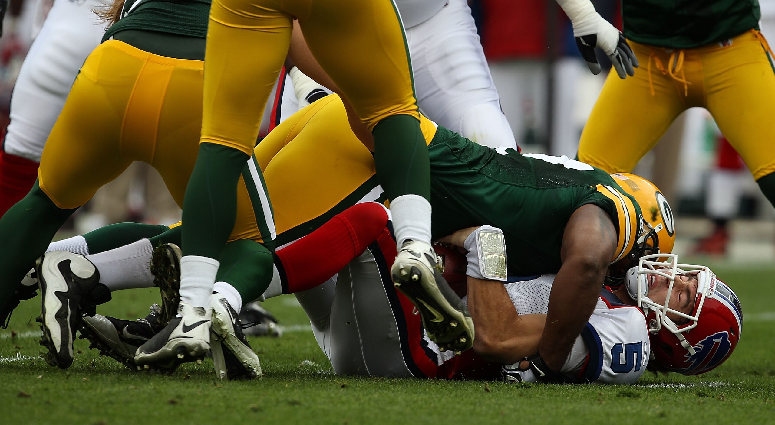 GREEN BAY, WI - SEPTEMBER 19: Cullen Jenkins #77 of the Green Bay Packers sacks Trent Edwards #5 of the Buffalo Bills at Lambeau Field on September 19, 2010 in Green Bay, Wisconsin. The Packers defeated the Bills 34-7. (Photo by Jonathan Daniel/Getty Imag
