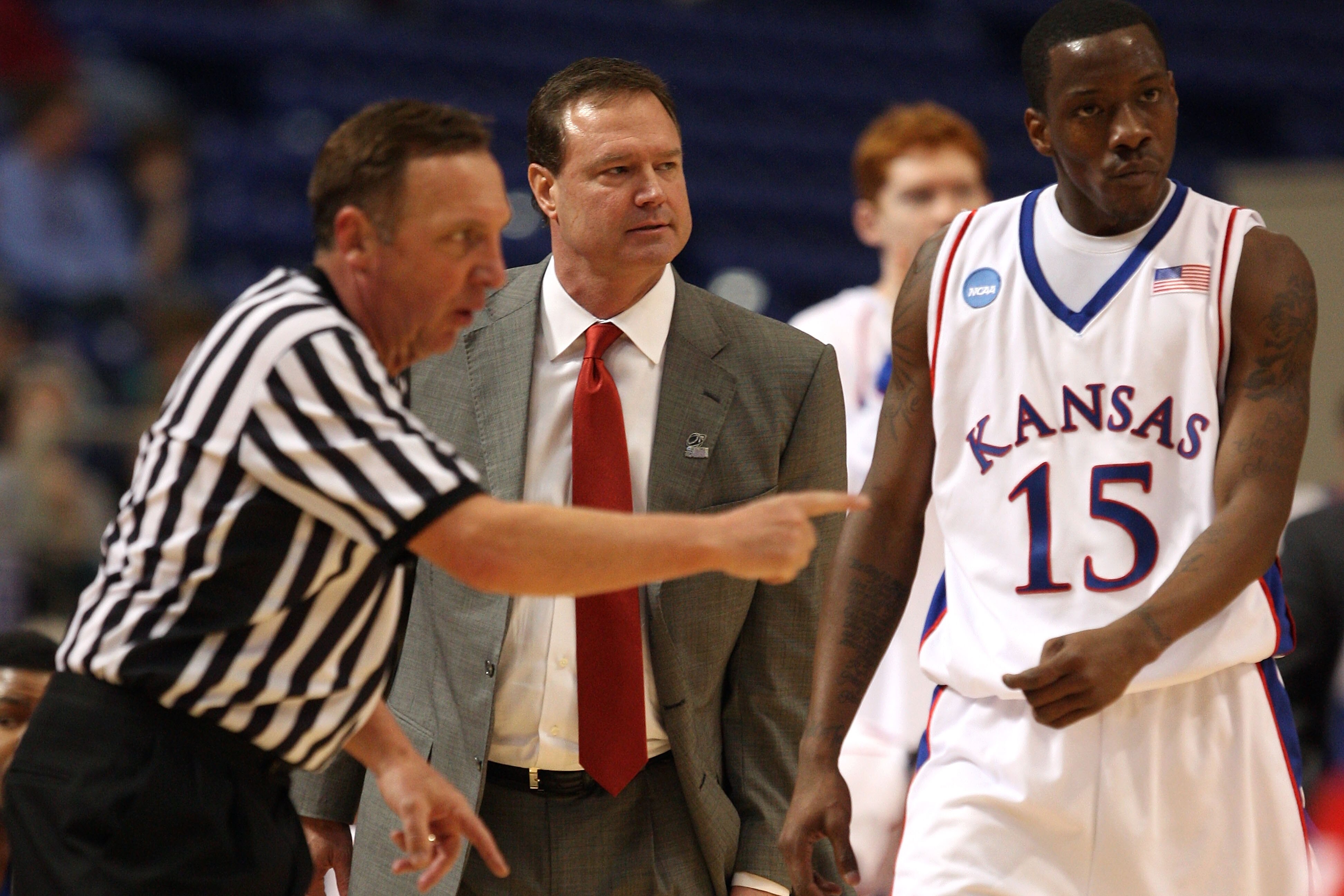 MINNEAPOLIS - MARCH 22:  Head coach Bill Self and Tyshawn Taylor #15 of the Kansas Jayhawks look on as the referee makes a call against the Dayton Flyers during the second round of the NCAA Division I Men's Basketball Tournament at the Hubert H. Humphrey