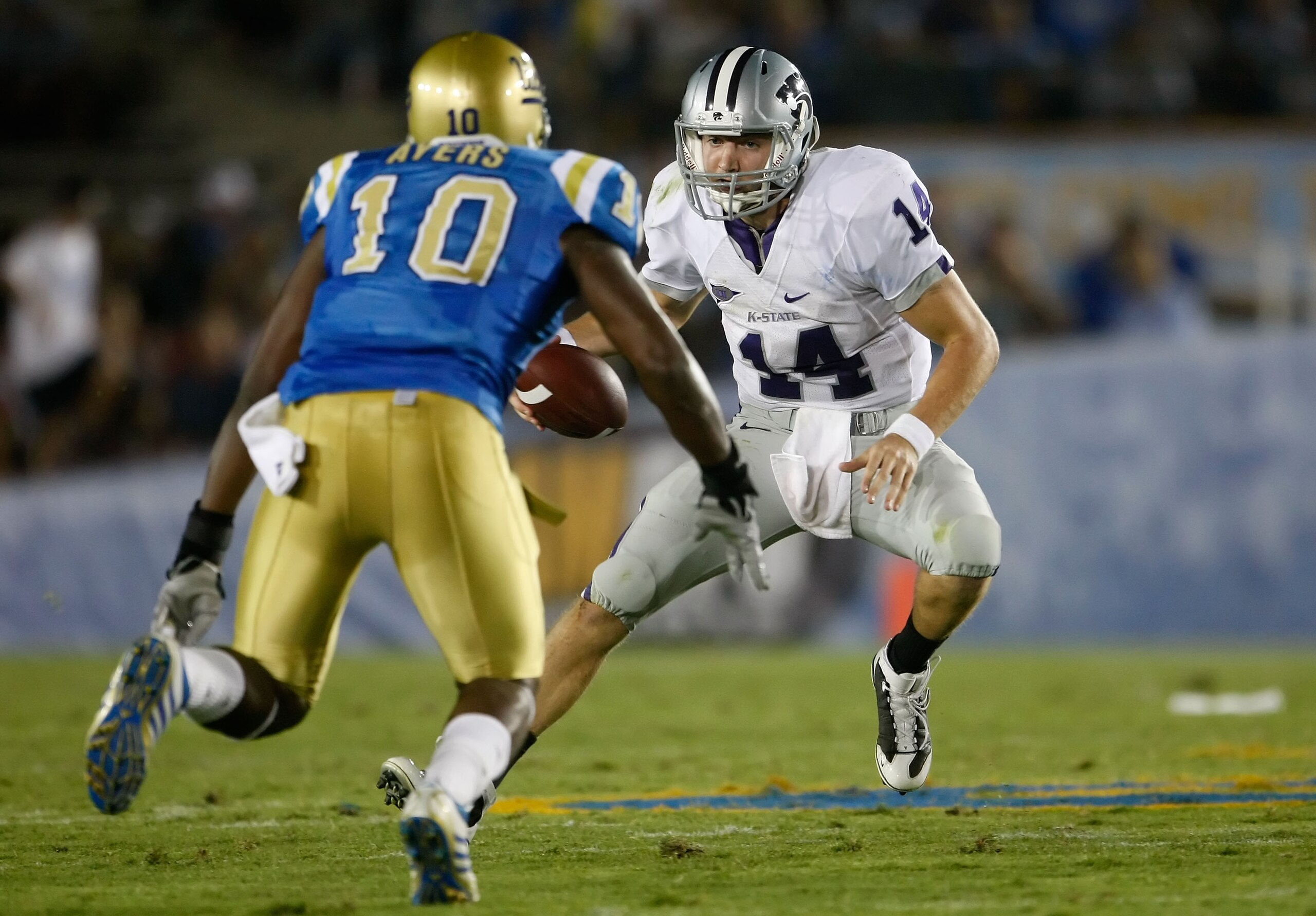 PASADENA, CA - SEPTEMBER 19:  Quarterback Carson Coffman #14 of the Kansas State Wildcats is met by Akeem Ayers #10 of the UCLA Bruins in the first half at the Rose Bowl on September 19, 2009 in Pasadena, California.  (Photo by Jeff Gross/Getty Images)
