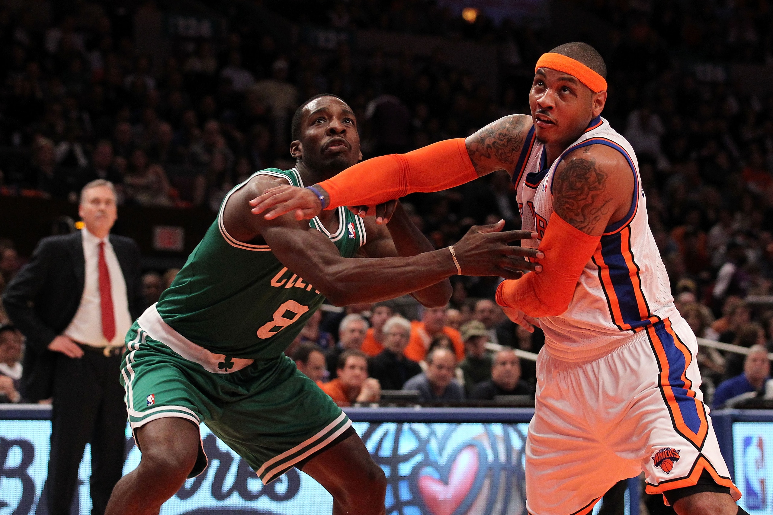 NEW YORK, NY - APRIL 22:  Carmelo Anthony #7 of the New York Knicks fights for rebound position against Jeff Green #8 of the Boston Celtics as Knicks head coach Mike D'Antoni (L) in the first half of Game Three of the Eastern Conference Quarterfinals in t