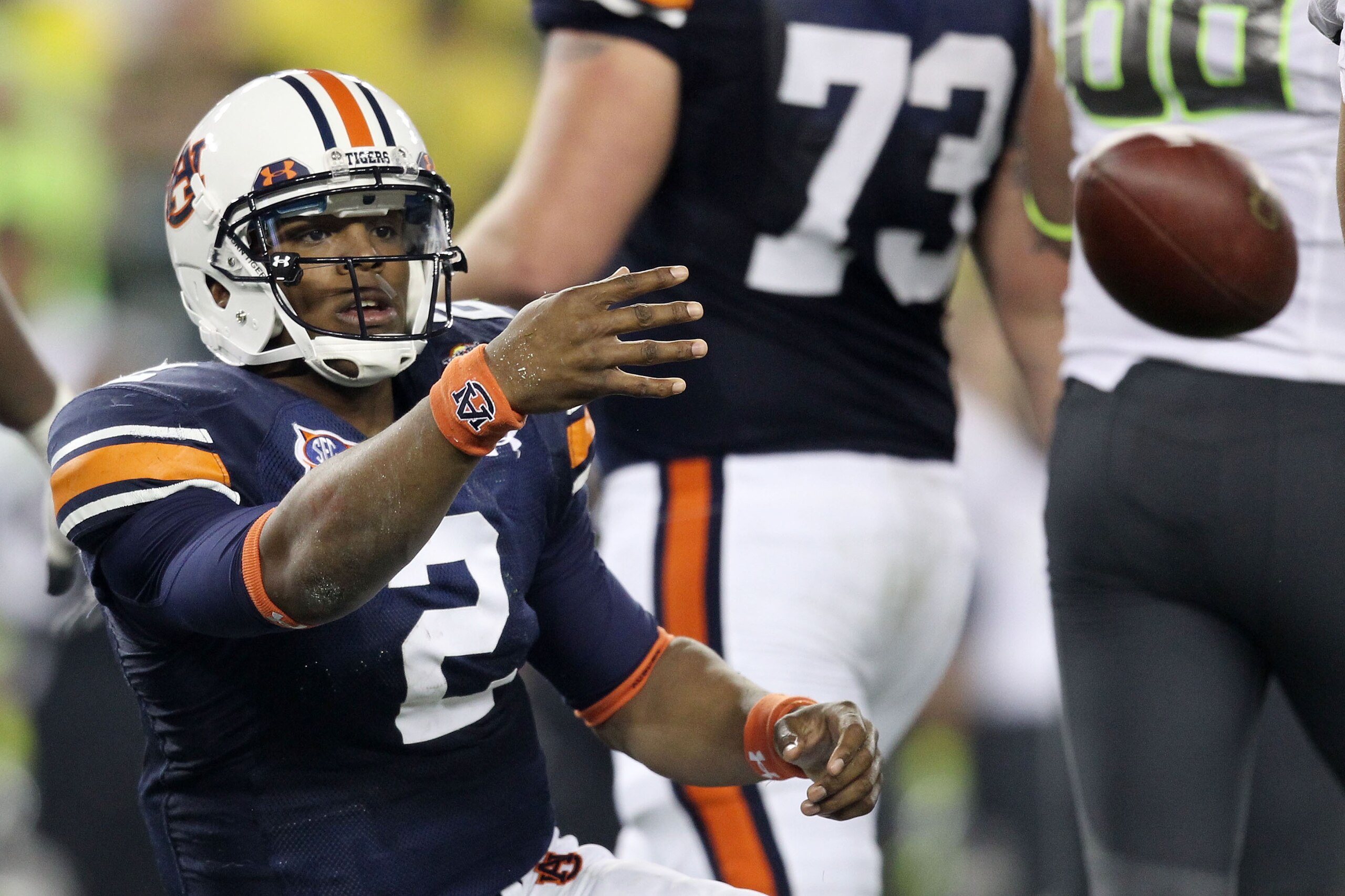 GLENDALE, AZ - JANUARY 10:  Cameron Newton #2 of the Auburn Tigers tosses the ball after being sacked by the Oregon Ducks during the Tostitos BCS National Championship Game at University of Phoenix Stadium on January 10, 2011 in Glendale, Arizona.  (Photo