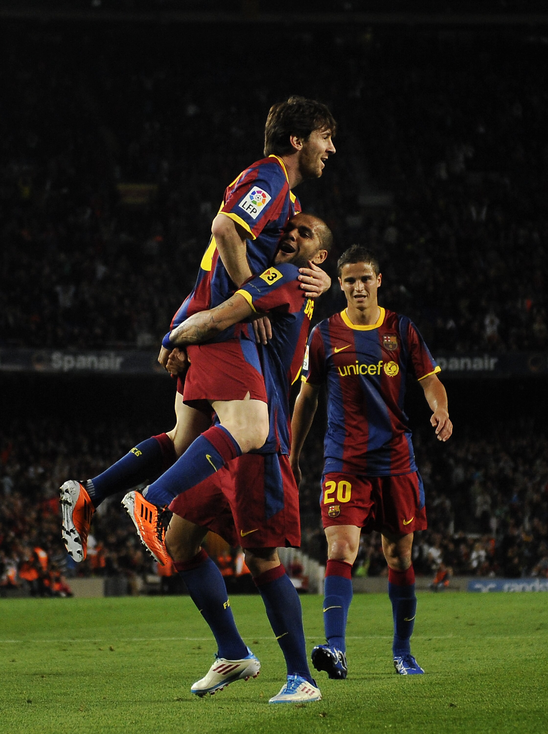 BARCELONA, SPAIN - APRIL 23:  Lionel Messi of FC Barcelona (L) celebrates with his teammates Dani Alves (C) and Ibrahim Afellay during the La Liga match between Barcelona and CA Osasuna at Camp Nou Stadium on April 23, 2011 in Barcelona, Spain. Barcelona