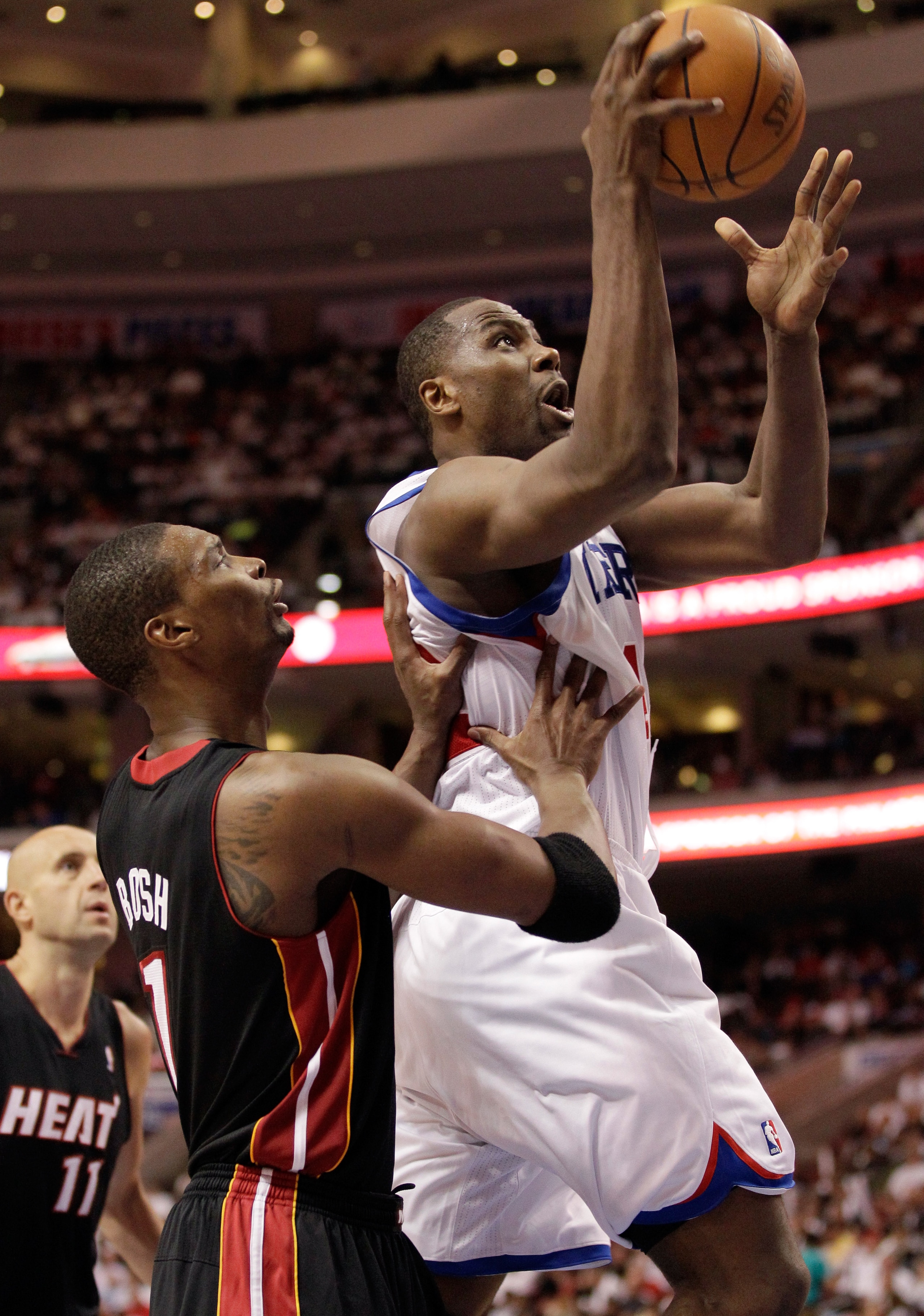 PHILADELPHIA, PA - APRIL 21: Elton Brand #42 of the Philadelphia 76ers (R) puts the ball up in front of Chris Bosh #1 of the Miami Heat during the second half of game three of the Eastern Conference Quarterfinals at Wells Fargo Center on April 21, 2011 in