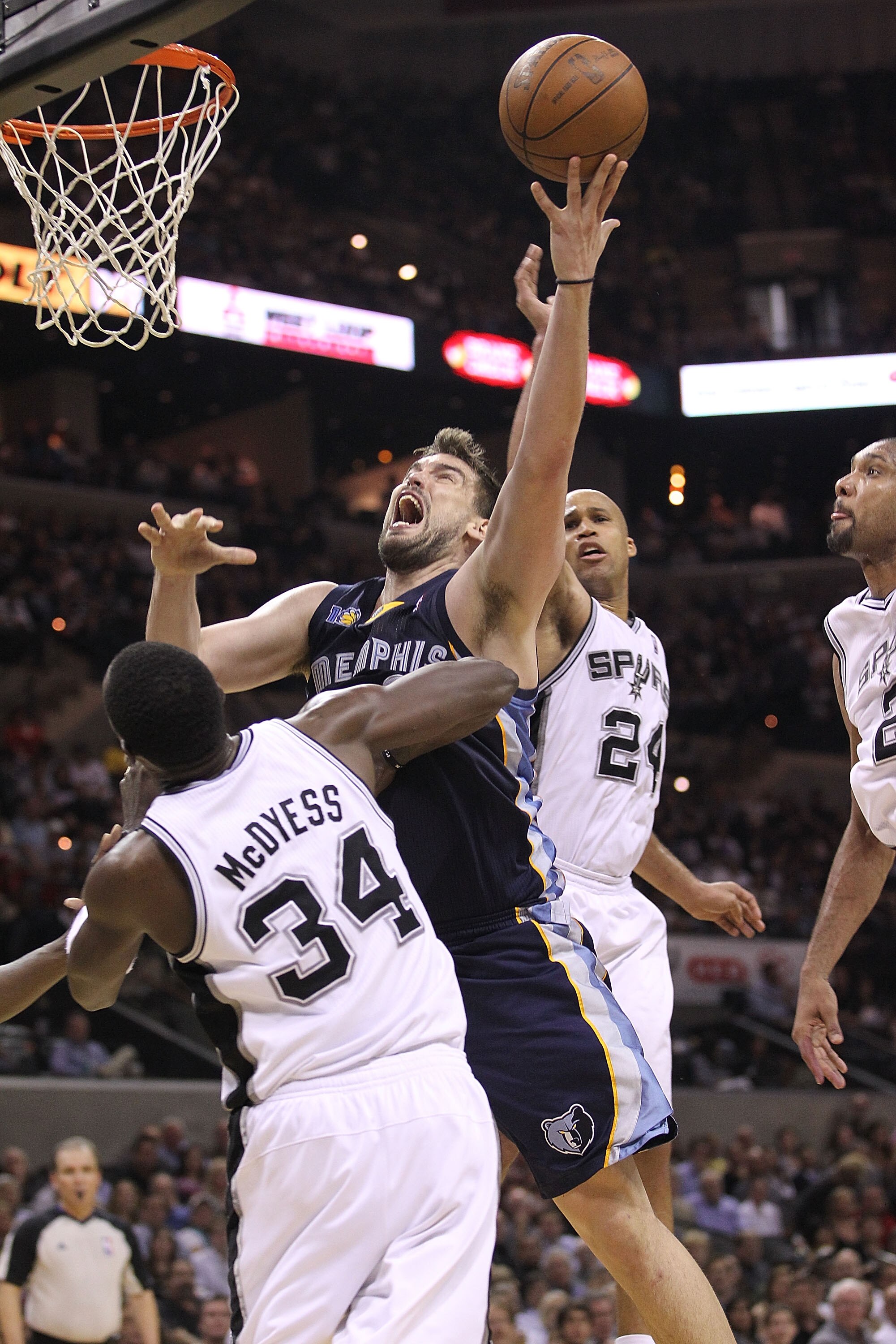 SAN ANTONIO, TX - APRIL 20:  Center Marc Gasol #33 of the Memphis Grizzlies takes a shot against Antonio McDyess #34 of the San Antonio Spurs in Game Two of the Western Conference Quarterfinals in the 2011 NBA Playoffs on April 20, 2011 at AT&T Center in