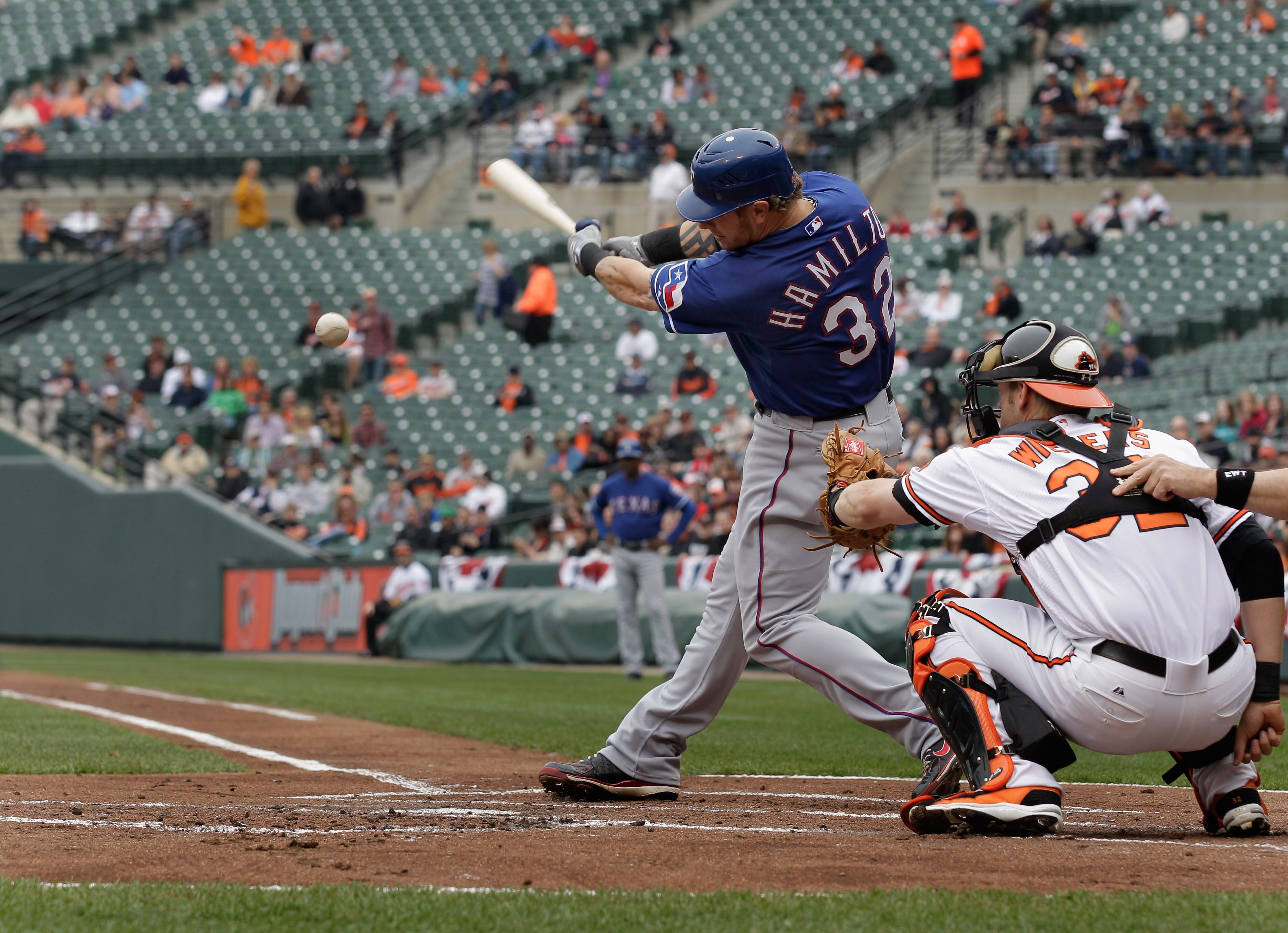 BALTIMORE, MD - APRIL 10:  Josh Hamilton #32 of the Texas Rangers at the plate as catcher Matt Wieters #32 of the Baltimore Orioles looks on at Oriole Park at Camden Yards on April 10, 2011 in Baltimore, Maryland.  (Photo by Rob Carr/Getty Images)