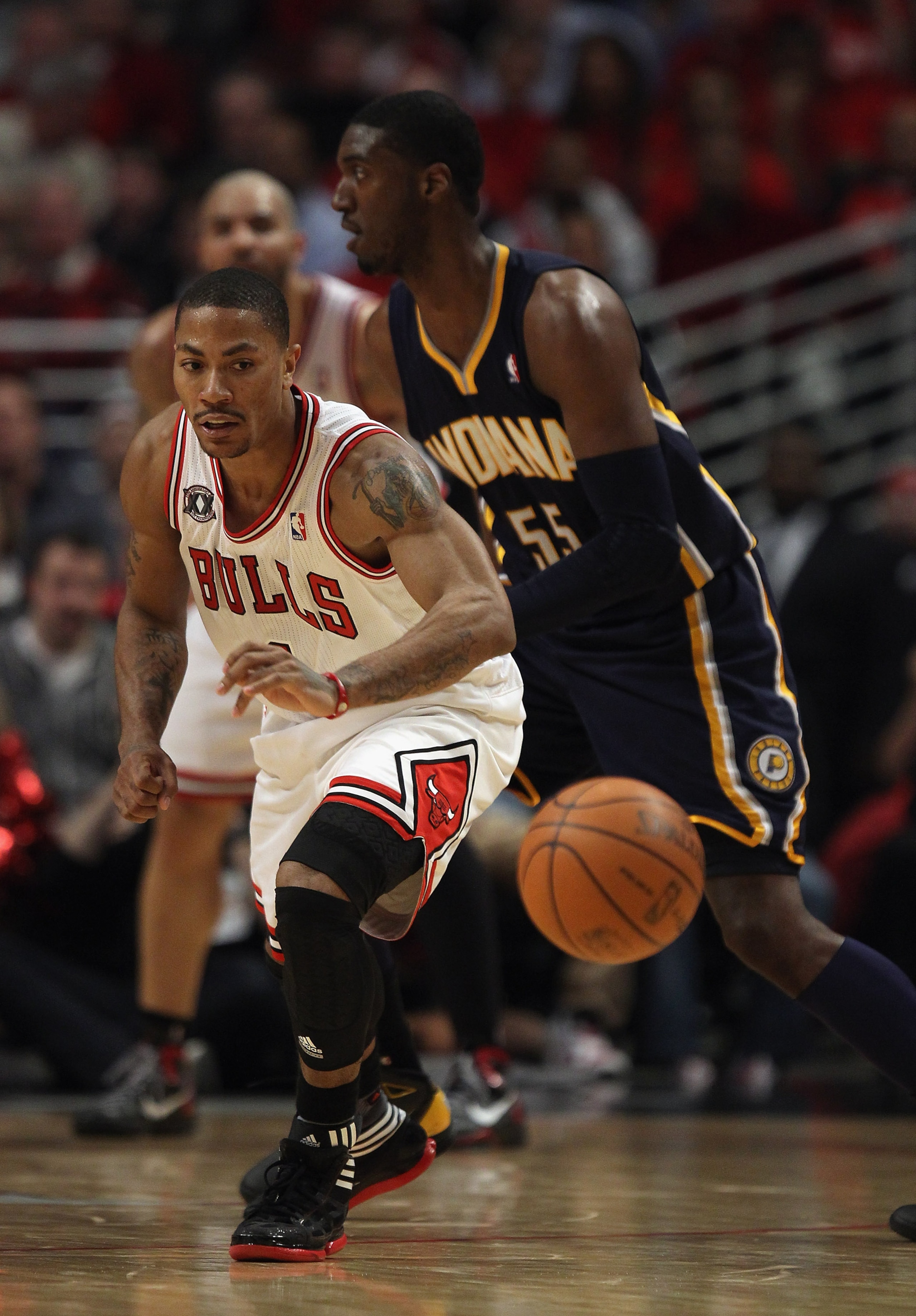 CHICAGO, IL - APRIL 18: Derrick Rose #1 of the Chicago Bulls moves to a loose ball next to Roy Hibbert #55 of the Indiana Pacer defense in Game Two of the Eastern Conference Quarterfinals in the 2011 NBA Playoffs at the United Center on April 18, 2011 in