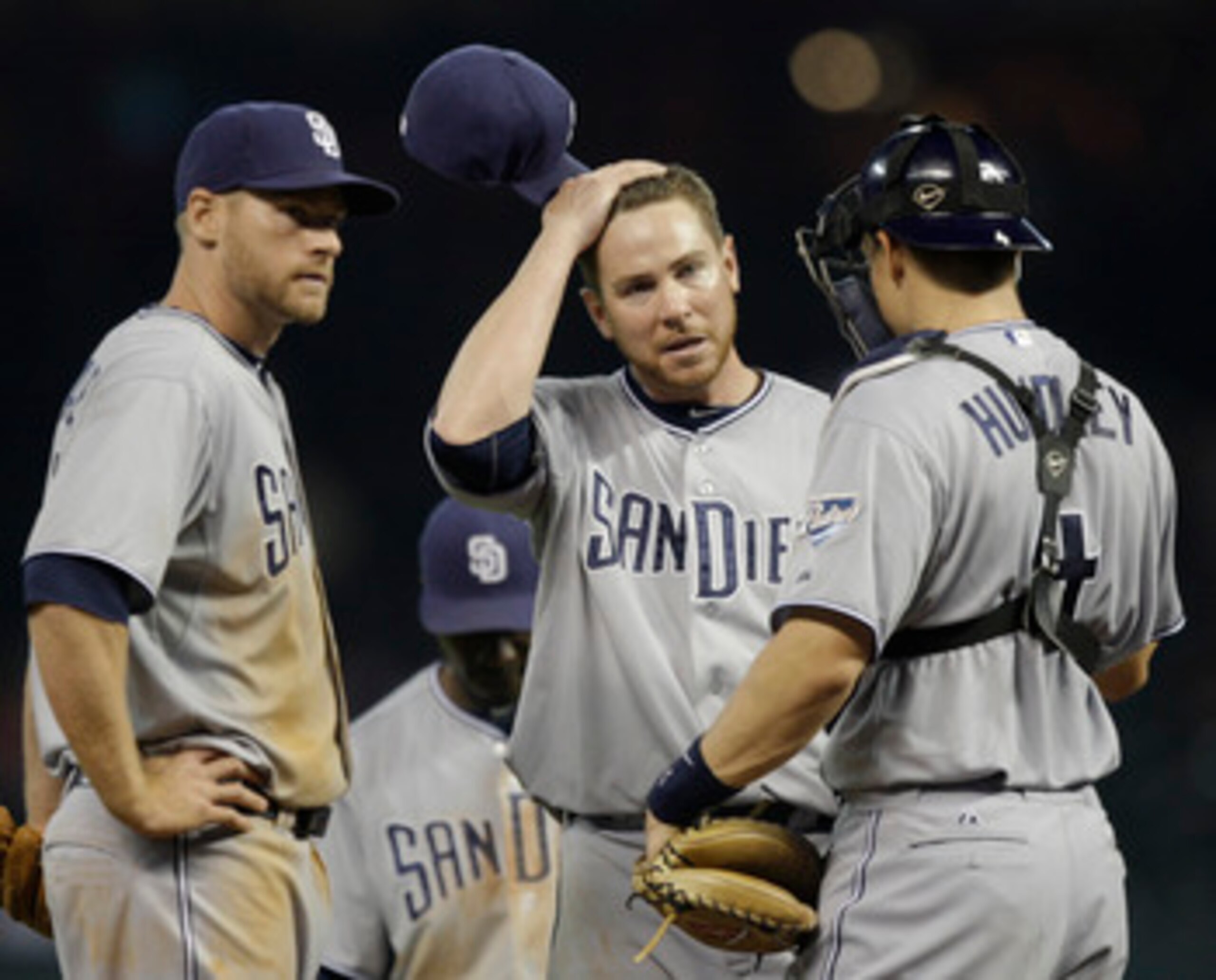 HOUSTON - APRIL 14:  Pitcher Dustin Moseley of the San Diego Padres,center, wipes his head as he talks with catcher Nick Hundley, right, and Chase Headley , left  at Minute Maid Park on April 14, 2011 in Houston, Texas.  (Photo by Bob Levey/Getty Images)