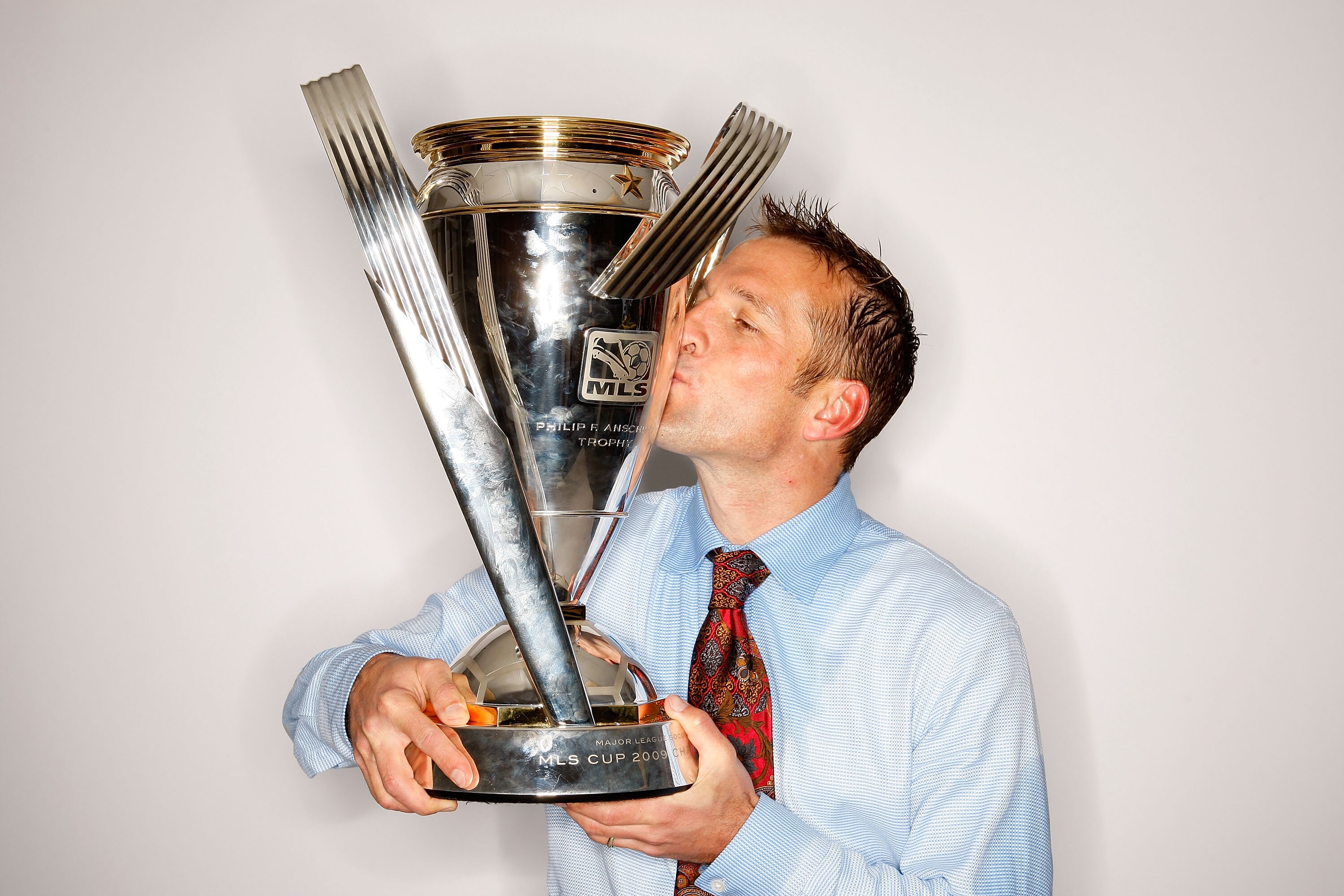 SEATTLE - NOVEMBER 22:  Real Salt Lake coach Jason Kreis poses with the Philip F. Anschutz MLS Cup trophy following their win in the MLS Cup final at Qwest Field on November 22, 2009 in Seattle, Washington.  (Photo by Harry How/Getty Images for MLS)