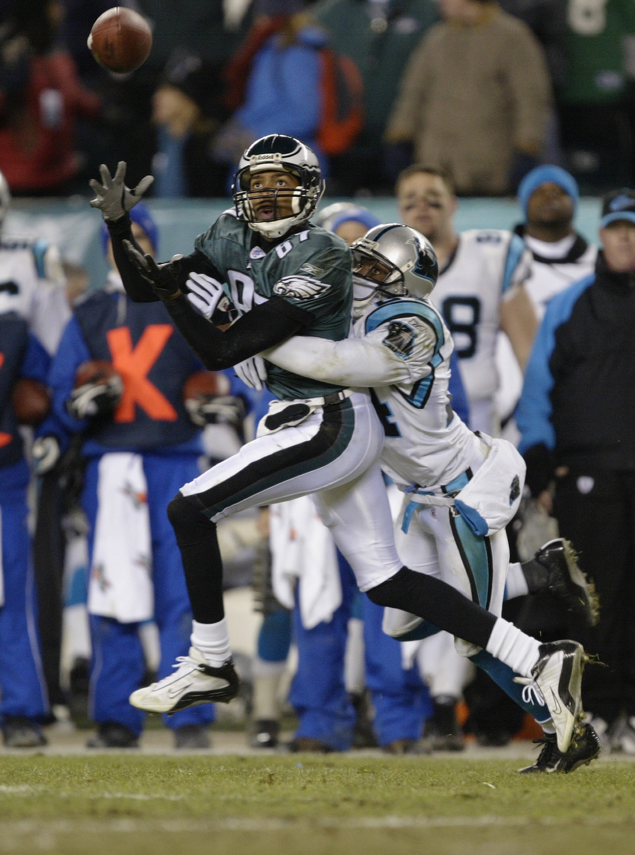 PHILADELPHIA - JANUARY 18:  Wide receiver Freddie Mitchell #84 of the Philadelphia Eagles goes out for a pass and is covered by Ricky Manning Jr. #24 of the Carolina Panthers in the NFC Championship game on January 18, 2004 at Lincoln Financial Field in P