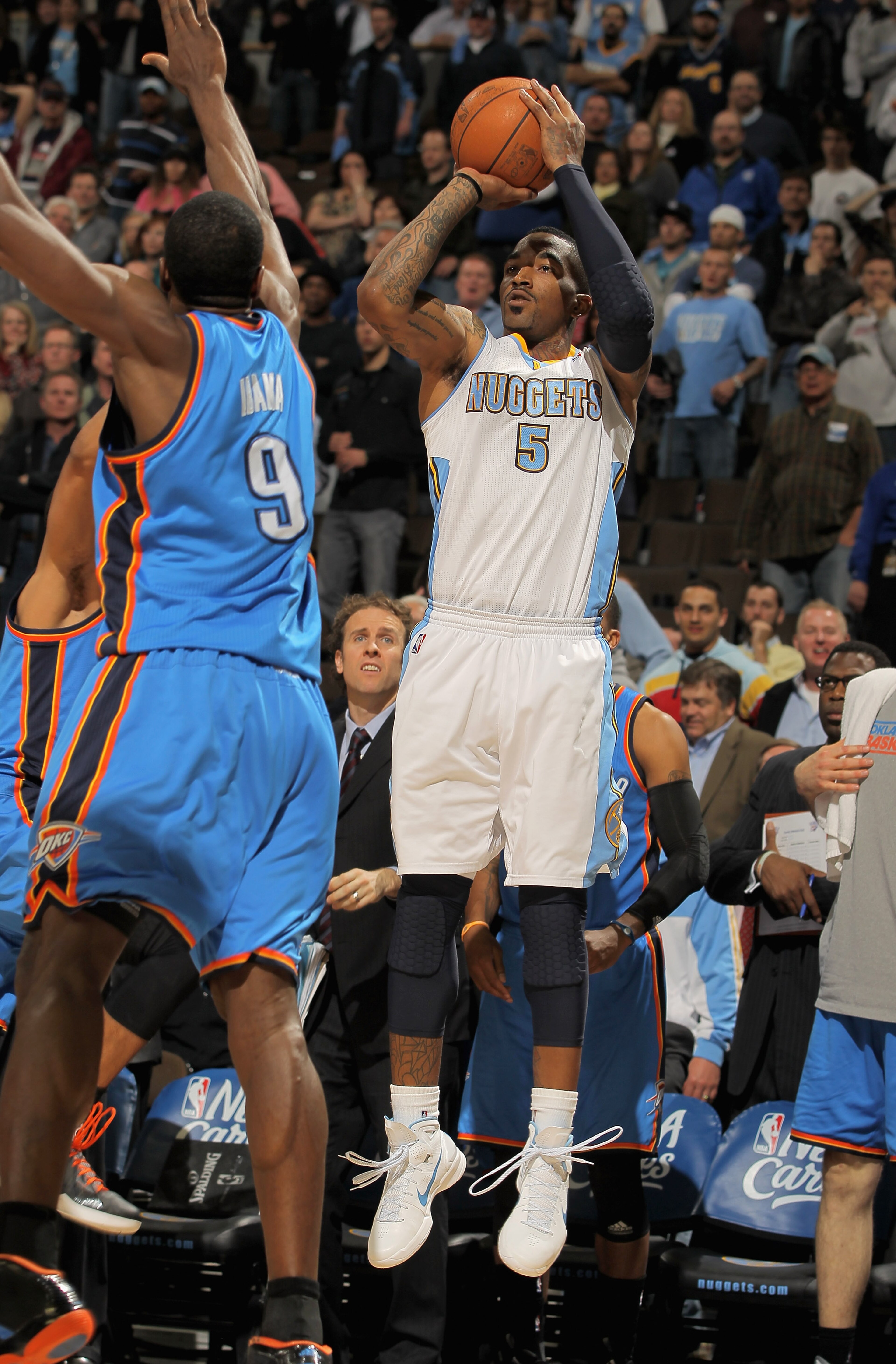 DENVER, CO - APRIL 23:  J.R. Smith #5 of the Denver Nuggets makes a three point over Serge Ibaka #9 of the Oklahoma City Thunder in the final minute of the in Game Three of the Western Conference Quarterfinals in the 2011 NBA Playoffs on April 23, 2011 at