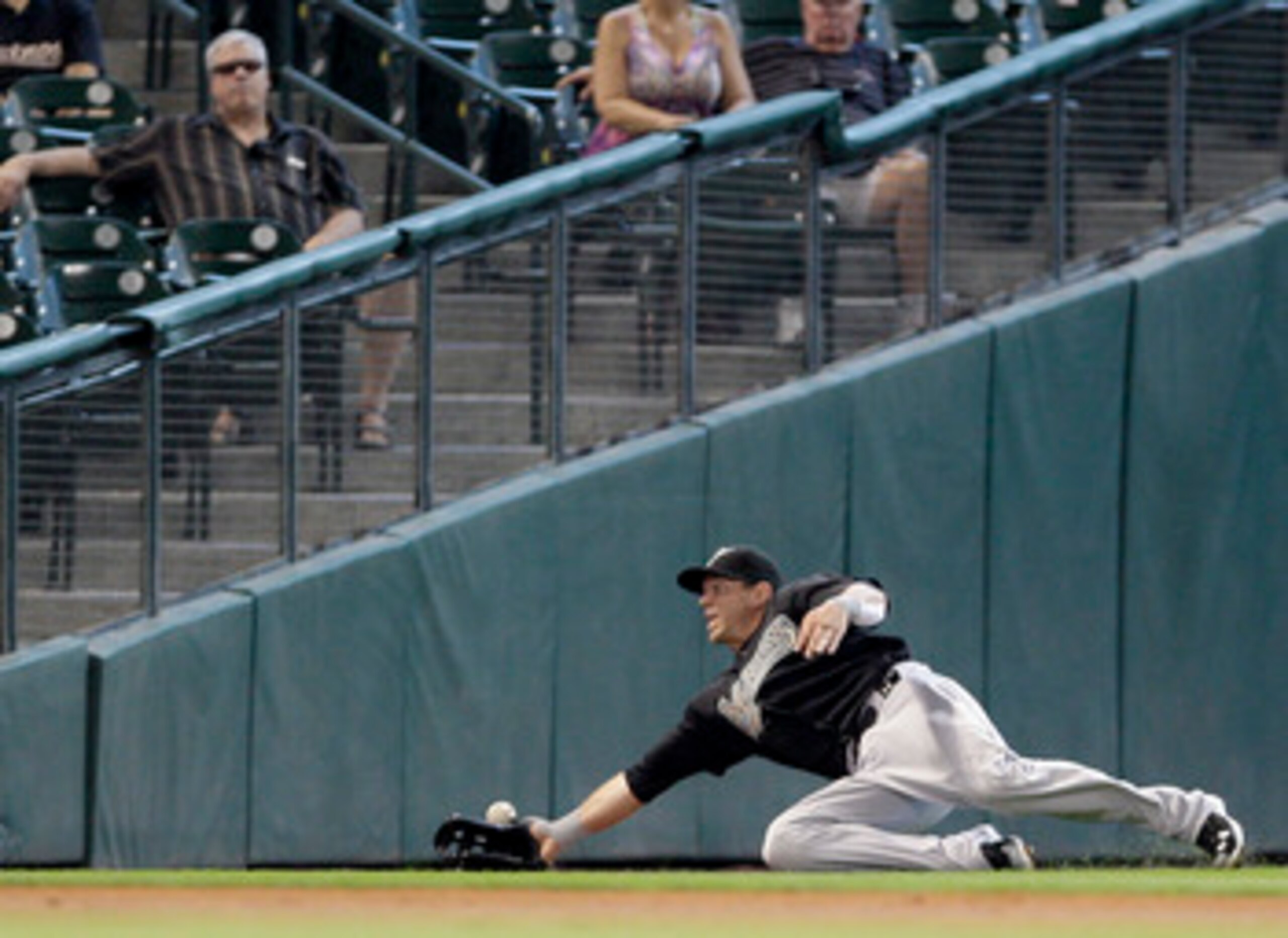 HOUSTON,TX- APRIL 10 : Left fielder Logan Morrison #20 of the Florida Marlins can't quite catch Michael Bourn of the Houston Astros double in the first inning in a MLB  baseball game on April 10, 2011 at Minute Maid Park in Houston, Texas. (Photo by Thoma