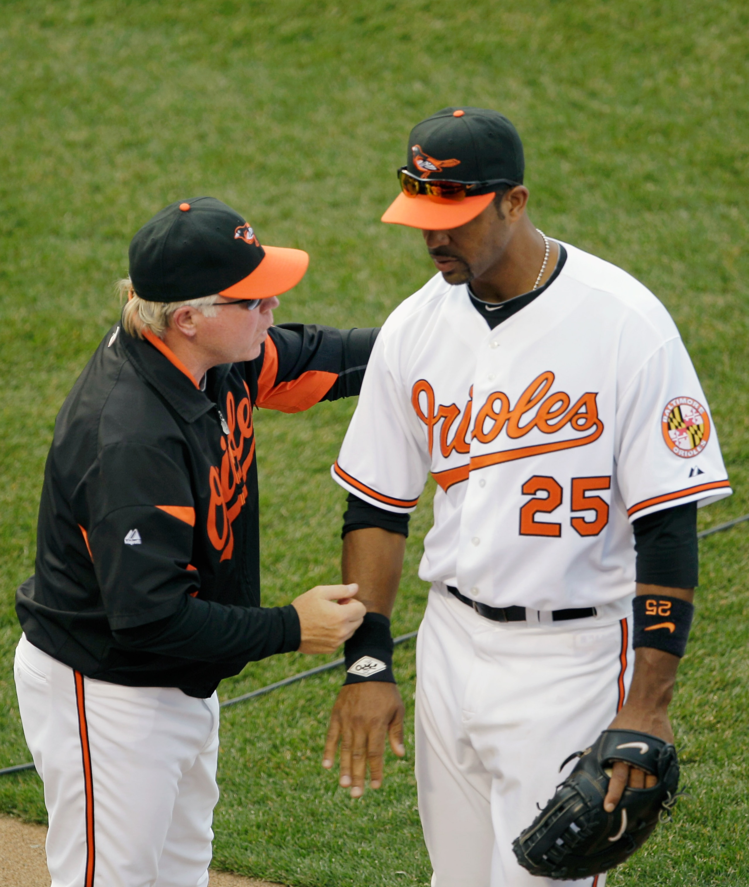 BALTIMORE, MD - APRIL 04: Manager Buck Showalter #26 of the Baltimore Orioles congratulates first baseman Derrek Lee #25 of the Baltimore Orioles after they defeated the Detroit Tigers during opening day at Oriole Park at Camden Yards on April 4, 2011 in BALTIMORE, MD - APRIL 04: Manager Buck Showalter #26 of the Baltimore Orioles congratulates first baseman Derrek Lee #25 of the Baltimore Orioles after they defeated the Detroit Tigers during opening day at Oriole Park at Camden Yards on April 4, 2011 in