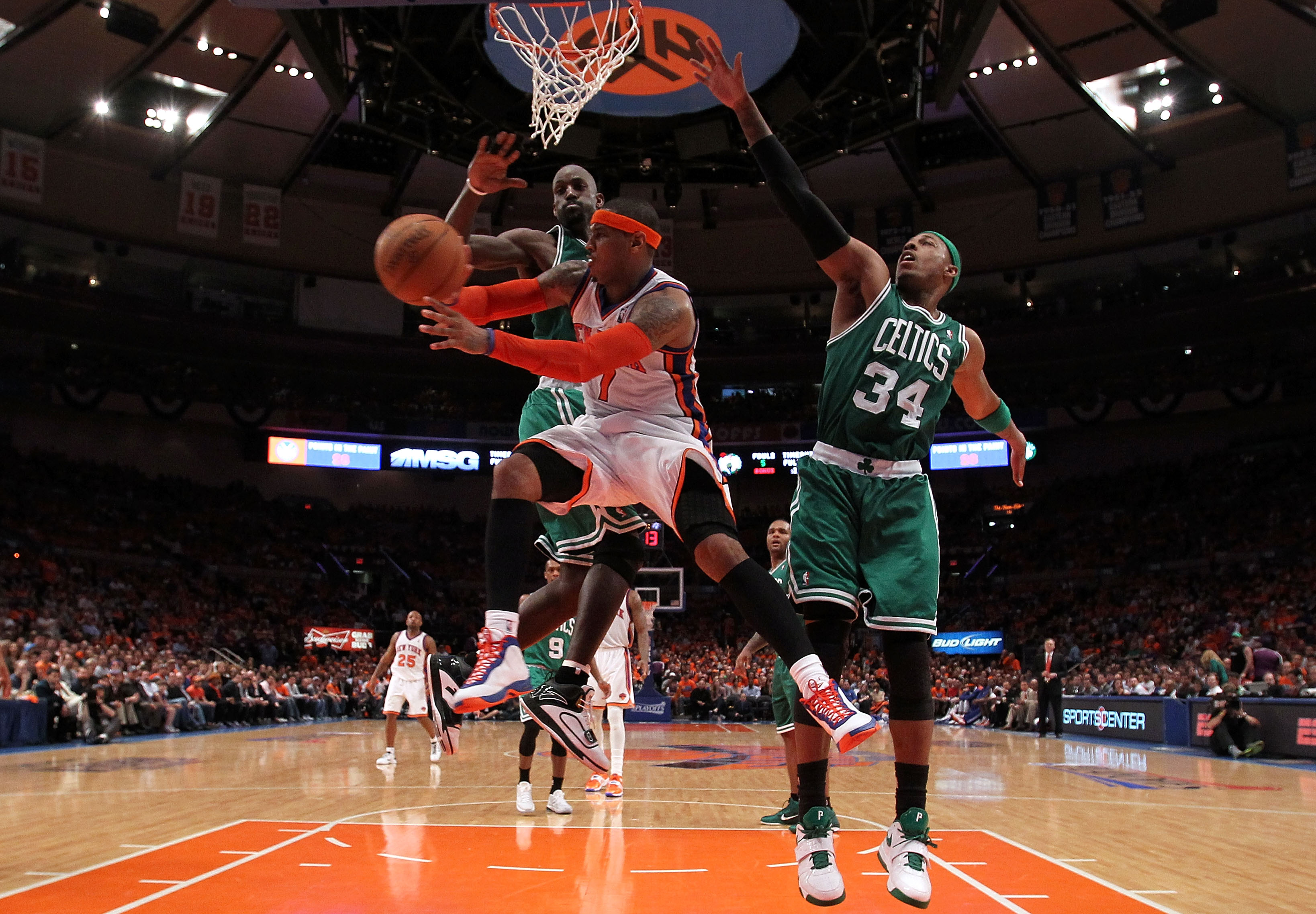 NEW YORK, NY - APRIL 24:  Carmelo Anthony #7 of the New York Knicks passes the ball as he drives against Kevin Garnett #5 and Paul Pierce #34 of the Boston Celtics in Game Four of the Eastern Conference Quarterfinals during the 2011 NBA Playoffs on April