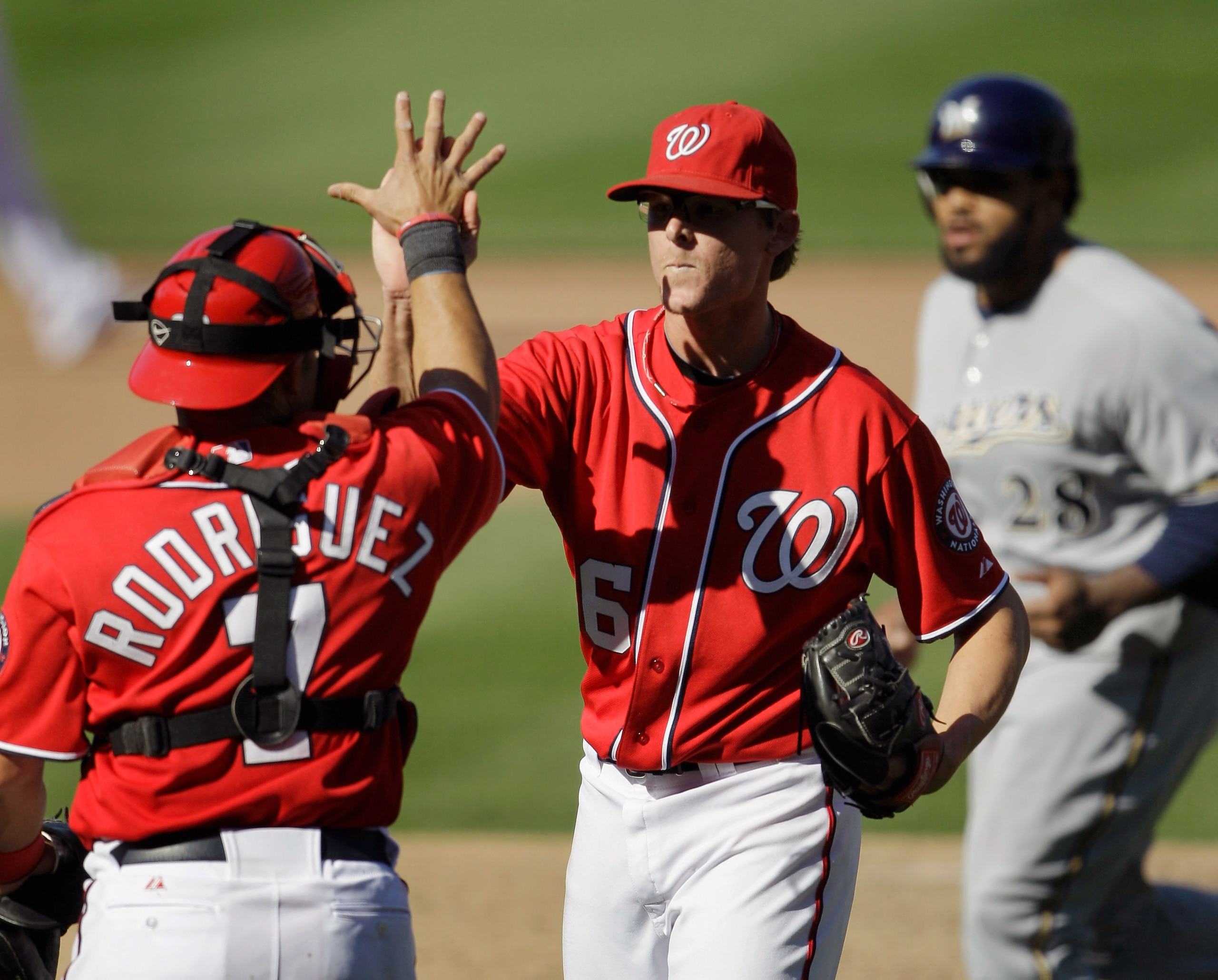 WASHINGTON, DC - APRIL 17: Prince Fielder #28 of the Milwaukee Brewers (R) walks off the field as Ivan Rodriguez #7 of the Washington Nationals celebrates with pitcher Tyler Clippard #36 after defeating the Brewers 8-4 during the first game of a doublehe WASHINGTON, DC - APRIL 17: Prince Fielder #28 of the Milwaukee Brewers (R) walks off the field as Ivan Rodriguez #7 of the Washington Nationals celebrates with pitcher Tyler Clippard #36 after defeating the Brewers 8-4 during the first game of a doublehe
