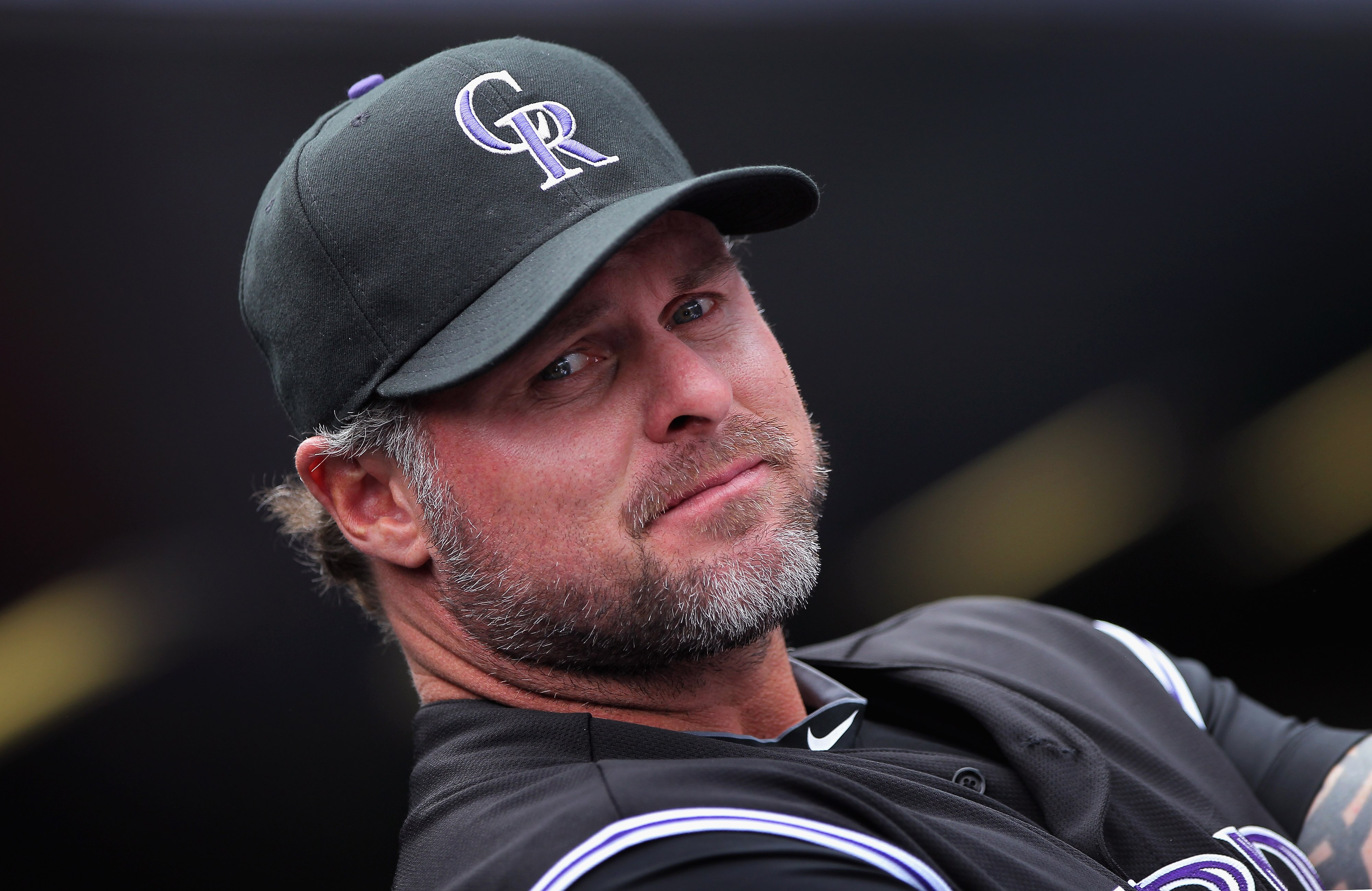 DENVER, CO - APRIL 17:  Jason Giambi #23 of the Colorado Rockies looks on from the dugout prior to facing the Chicago Cubs at Coors Field on April 17, 2011 in Denver, Colorado.  (Photo by Doug Pensinger/Getty Images)