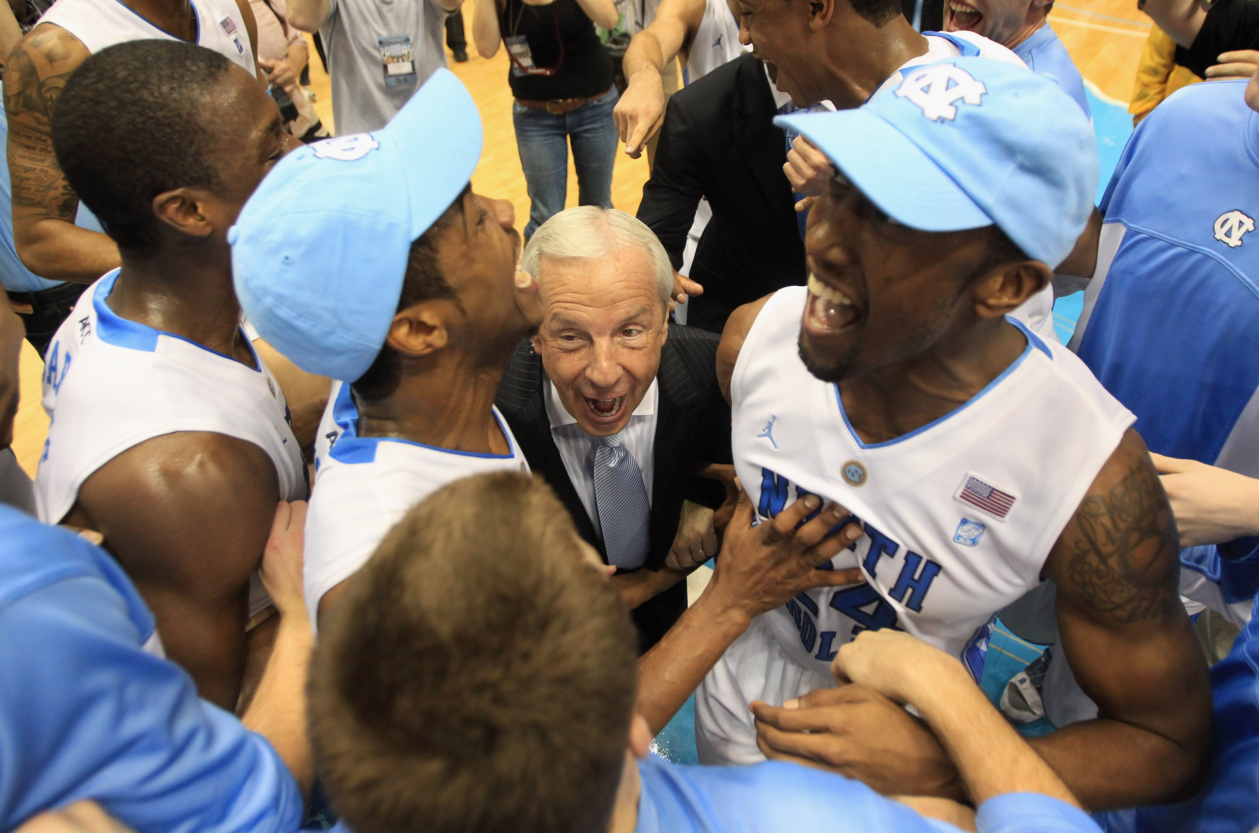 CHAPEL HILL, NC - MARCH 05:  Head coach Roy Williams of the North Carolina Tar Heels celebrates winning the ACC Regular Season Championship with his players as they defeated the Duke Blue Devils 81-67 at the Dean E. Smith Center on March 5, 2011 in Chapel