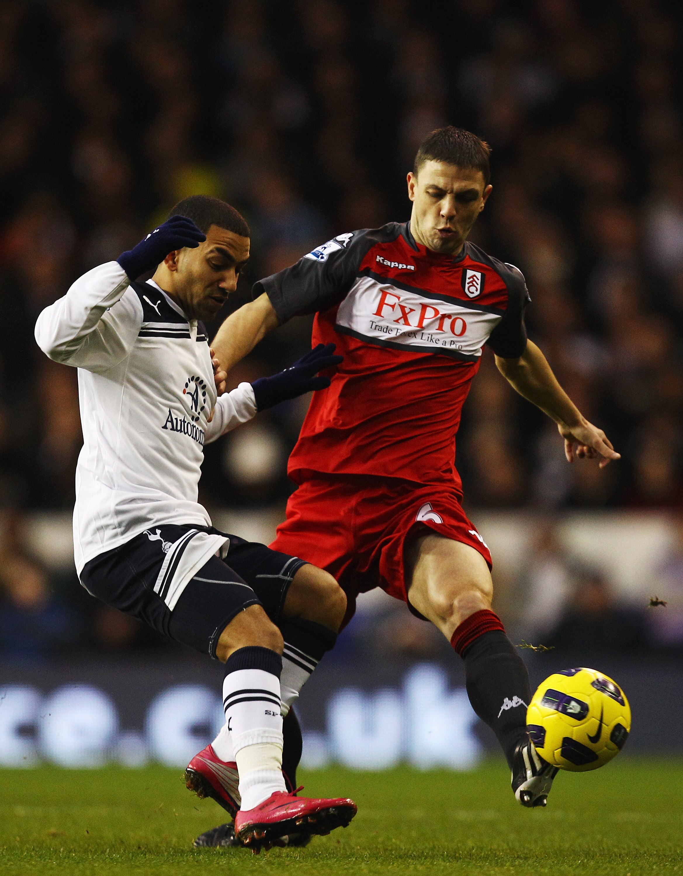 LONDON, UNITED KINGDOM - JANUARY 01:  Aaron Lennon (L) of Tottenham Hotspur is tackled by Chris Baird (R) of Fulham during the Barclays Premier League match between Tottenham Hotspur and Fulham at White Hart Lane on January 1, 2011 in London, England.  (P