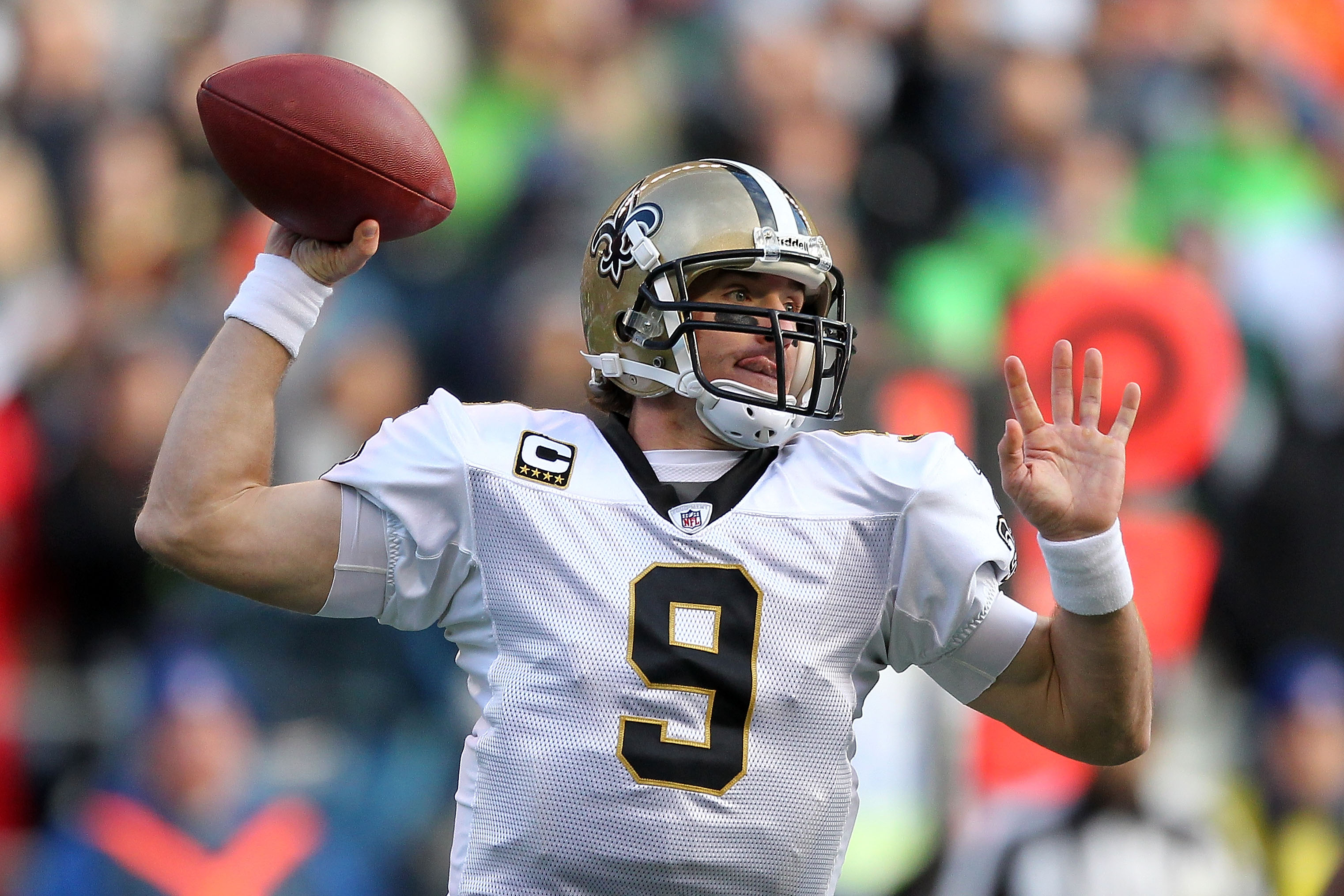 SEATTLE, WA - JANUARY 08:  Quarterback Drew Brees #9 of the New Orleans Saints throws the ball in the first half against the Seattle Seahawks during the 2011 NFC wild-card playoff game at Qwest Field on January 8, 2011 in Seattle, Washington.  (Photo by O
