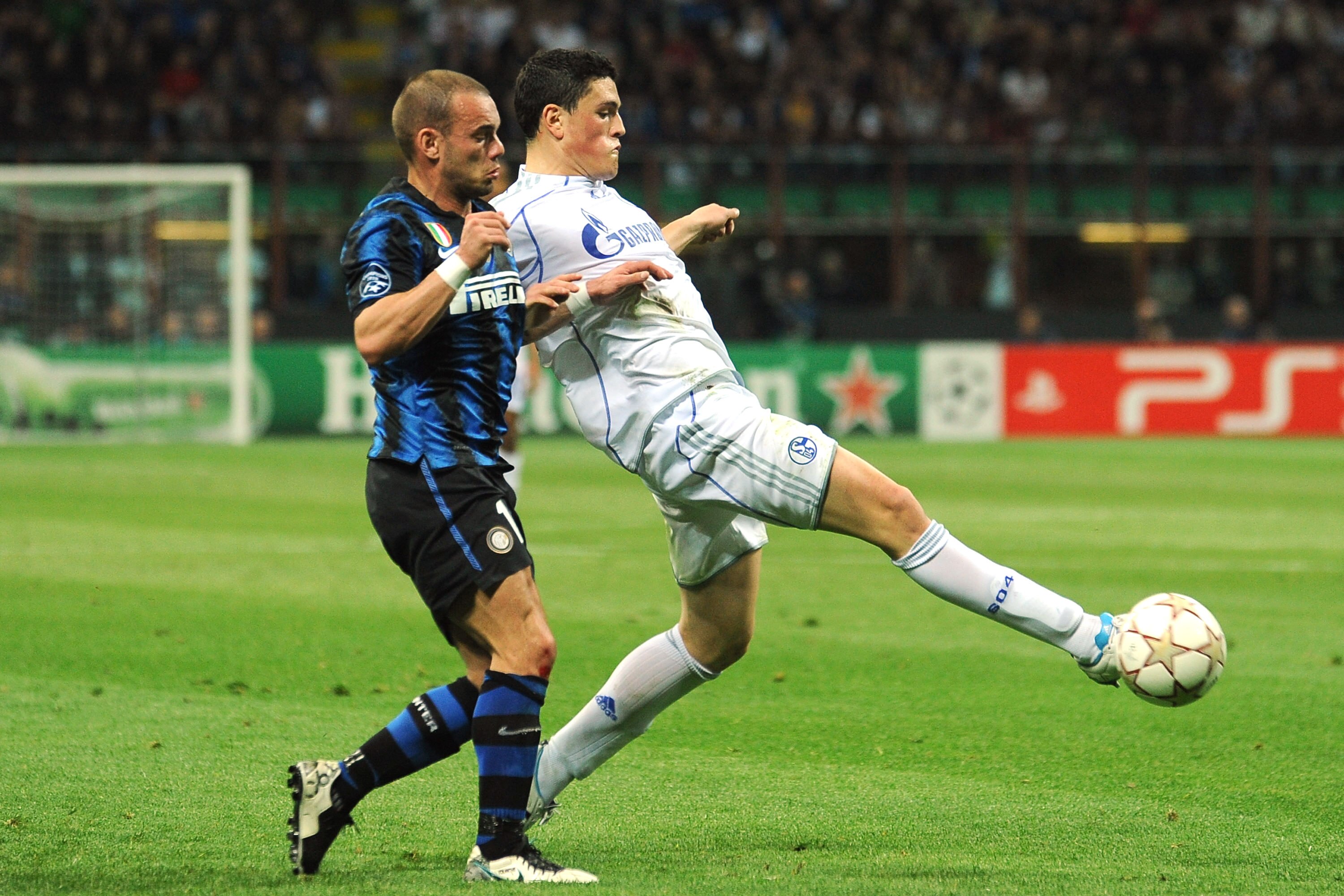 MILAN, ITALY - APRIL 05:  Kyriakos Papadopoulos (R) of Schalke 04 is challenged by Wesley Sneijder of FC Internazionale Milano during the UEFA Champions League Quarter Final match between FC Internazionale Milano and Schalke 04 at San Siro Stadium on Apri