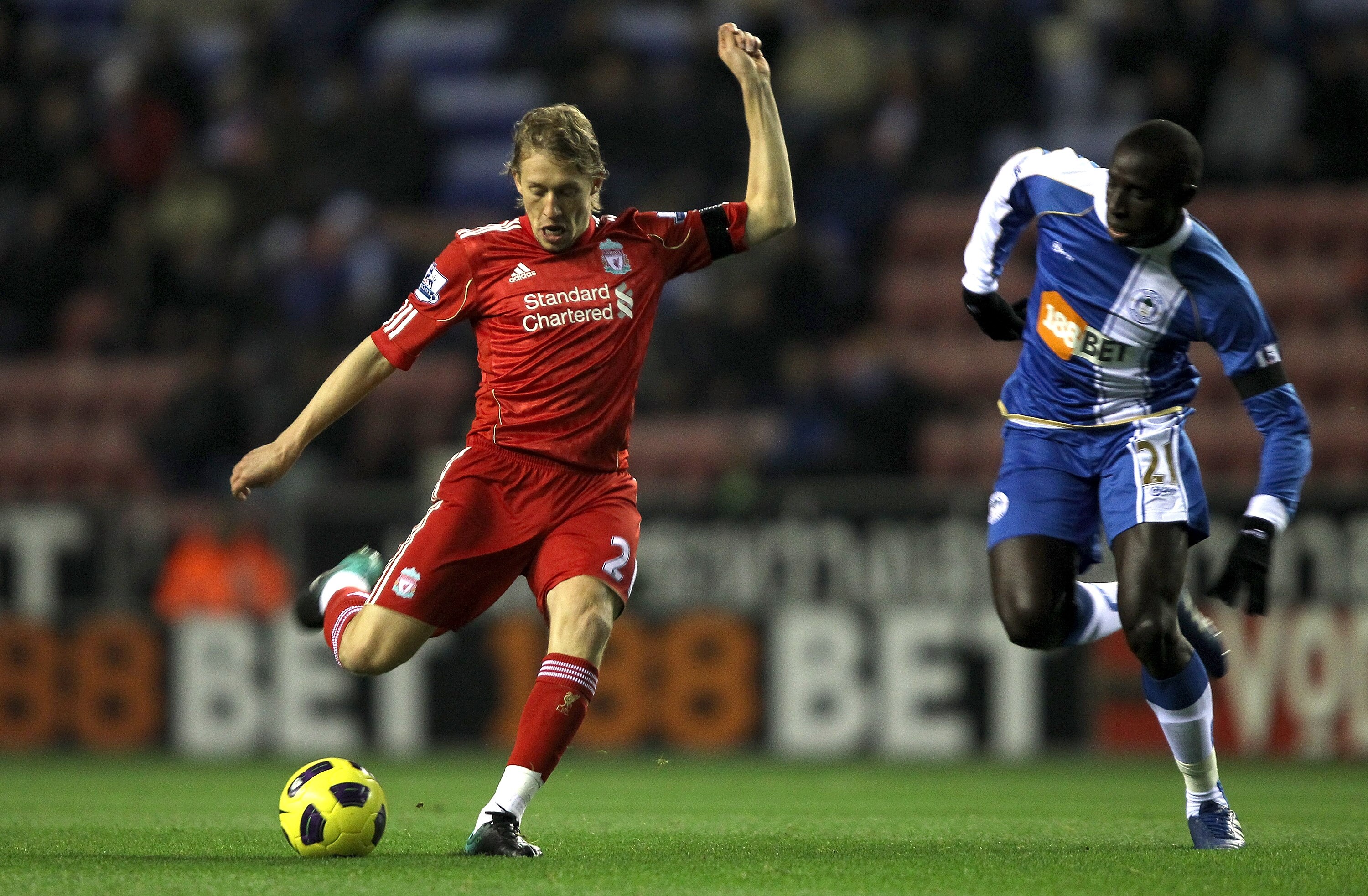 WIGAN, ENGLAND - NOVEMBER 10: Lucas Leiva of Liverpool attempts to shoot past Mohamed Diame of Wigan Athletic during the Barclays Premier League match between Wigan Athletic and Liverpool at DW Stadium on November 10, 2010 in Wigan, England.  (Photo by Cl