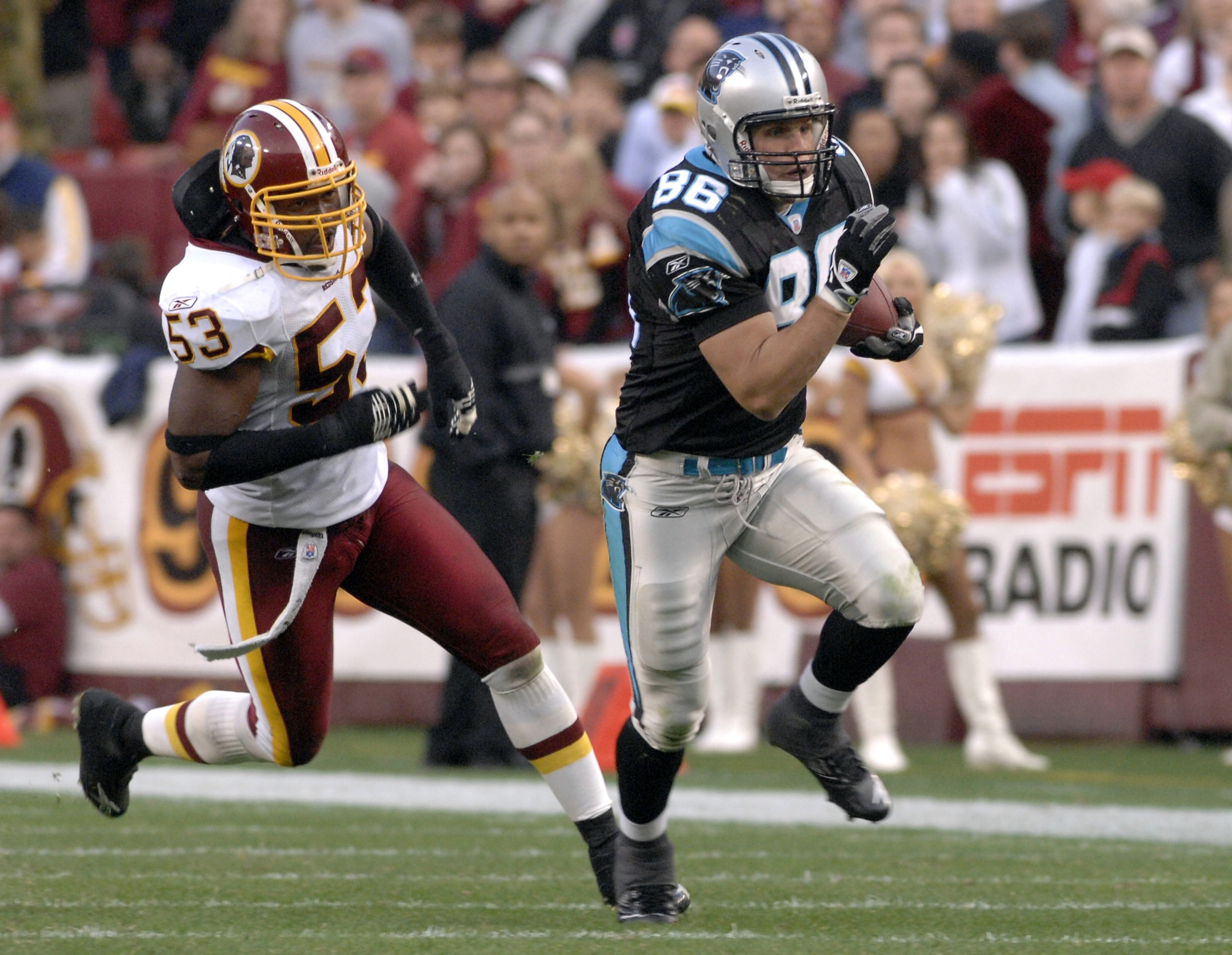 Carolina Panthers tight end Kris Mangum runs away from  Washington Redskins  linebacker Marcus Washington Nov. 26, 2006 at FedEx Field in Washington. The Skins won 17 - 10.  (Photo by Al Messerschmidt/Getty Images)
