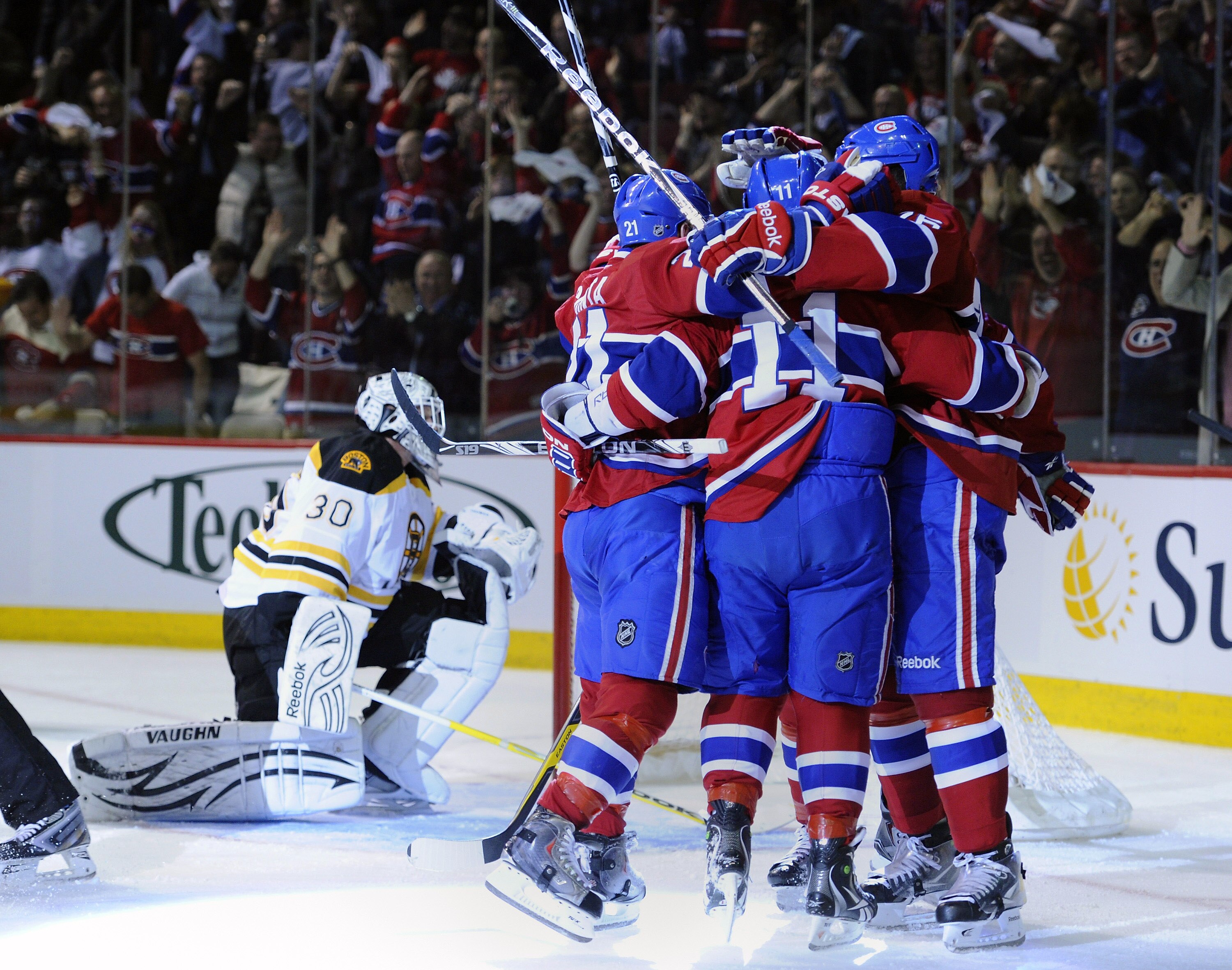 MONTREAL, QC - APRIL 21:  Tim Thomas #30 of the Boston Bruins looks into his net dejectedly while Brian Gionta #21;Scott Gomez #11 and P.K. Subban #76 of the Montreal Canadiens celebrate a goal in Game Four of the Eastern Conference Quarterfinals during t