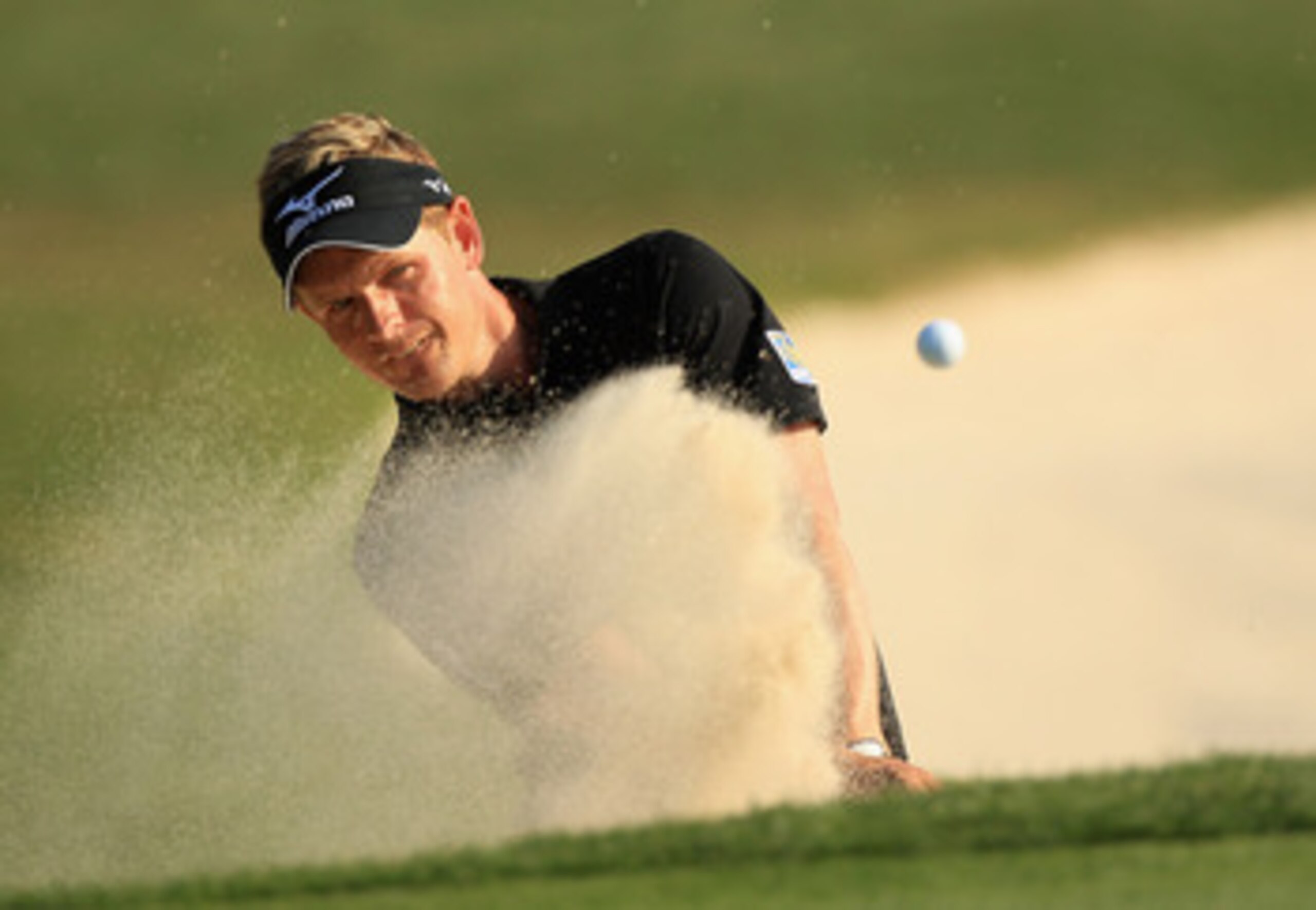 HILTON HEAD ISLAND, SC - APRIL 24:  Luke Donald of England hits a shot from the sand on the 18th hole during the final round of The Heritage at Harbour Town Golf Links on April 24, 2011 in Hilton Head Island, South Carolina.  (Photo by Streeter Lecka/Gett