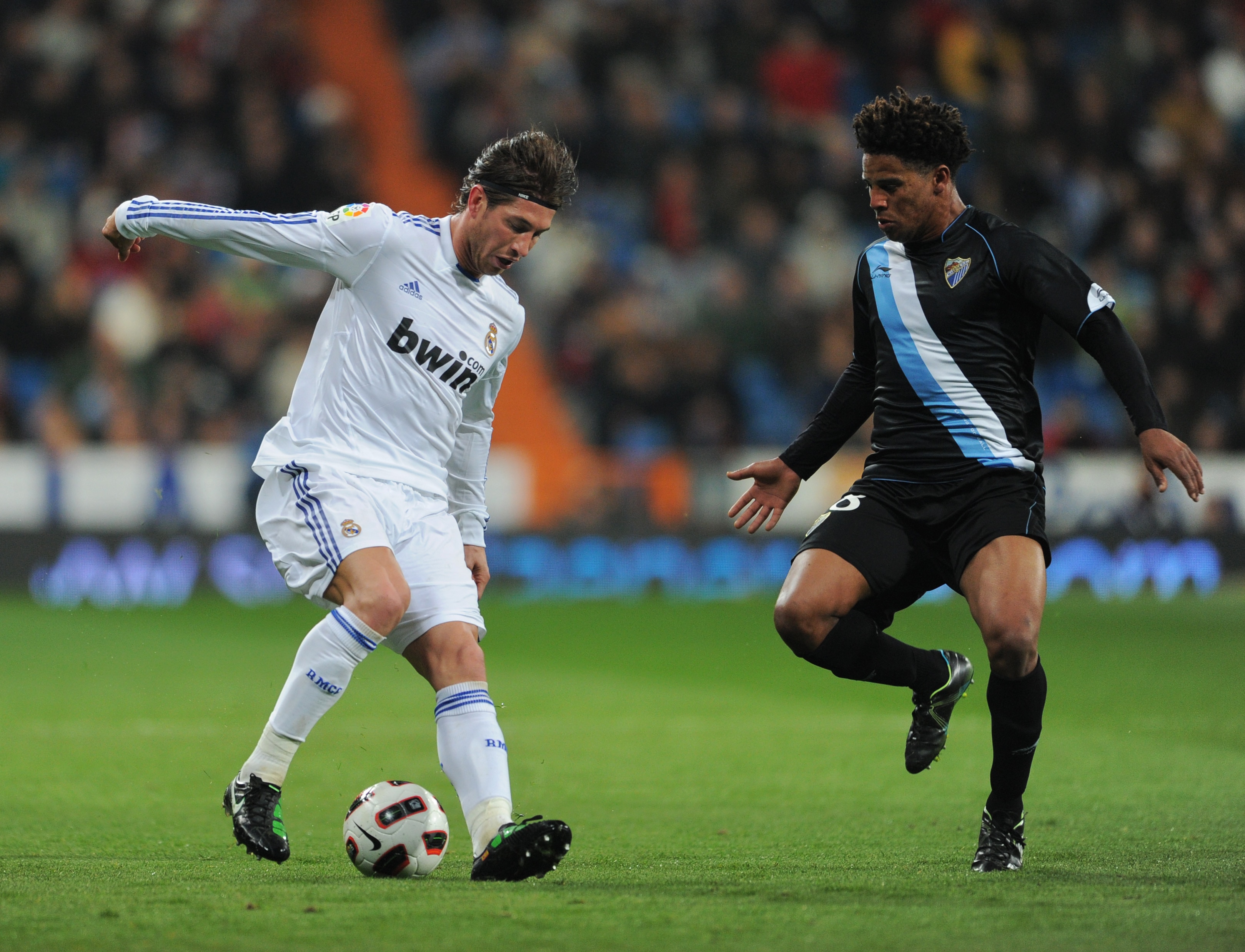 MADRID, SPAIN - MARCH 03:  Sergio Ramos (L) of Real Madrid duels for the ball with Eliseu Dos Santos of Malaga during the la Liga match between Real Madrid and Malaga at Estadio Santiago Bernabeu on March 3, 2011 in Madrid, Spain.  (Photo by Jasper Juinen