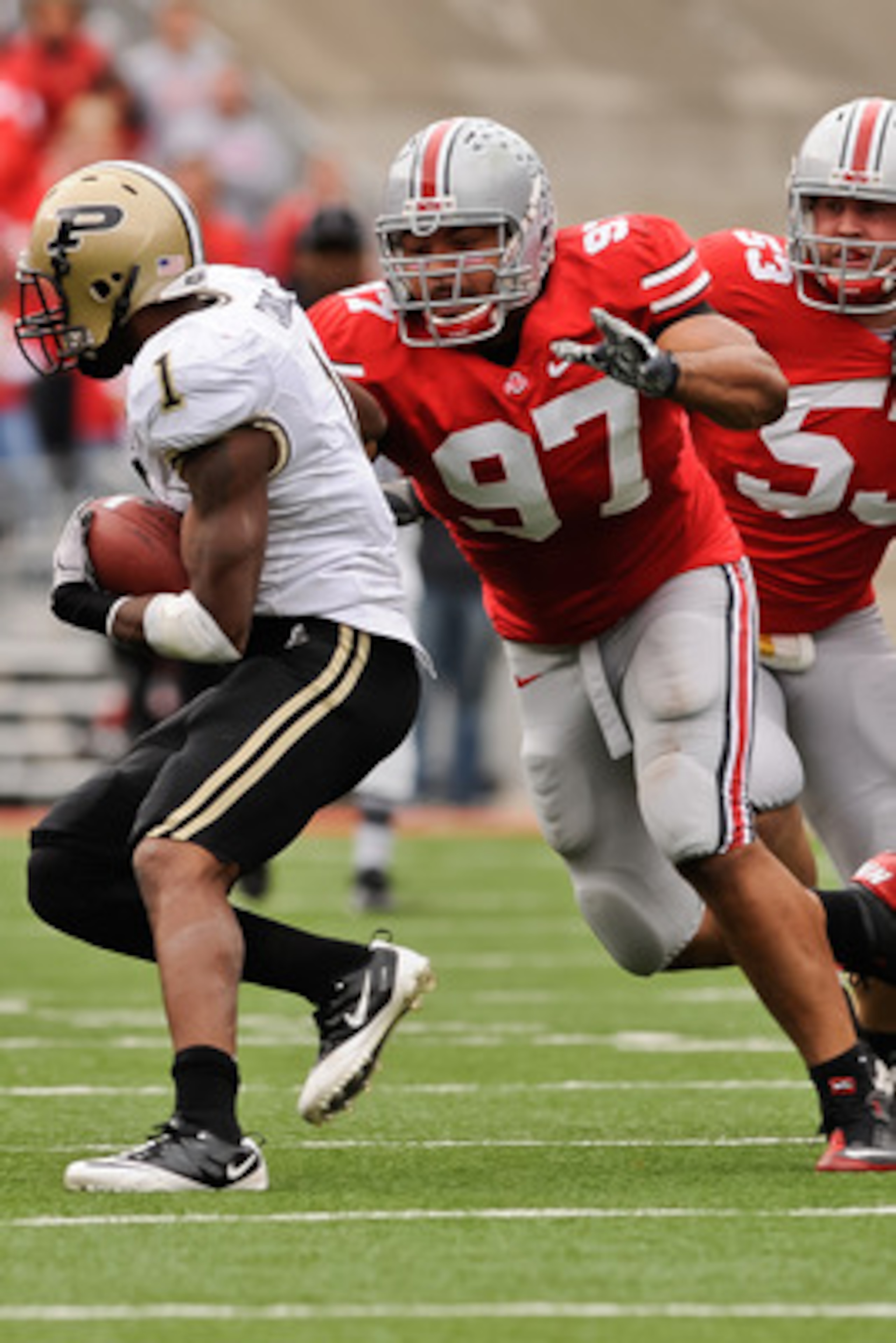 COLUMBUS, OH - OCTOBER 23:  Cameron Heyward #97 of the Ohio State Buckeyes chases down ballcarrier Keith Carlos #1 of the Purdue Boilermakers at Ohio Stadium on October 23, 2010 in Columbus, Ohio.  (Photo by Jamie Sabau/Getty Images)
