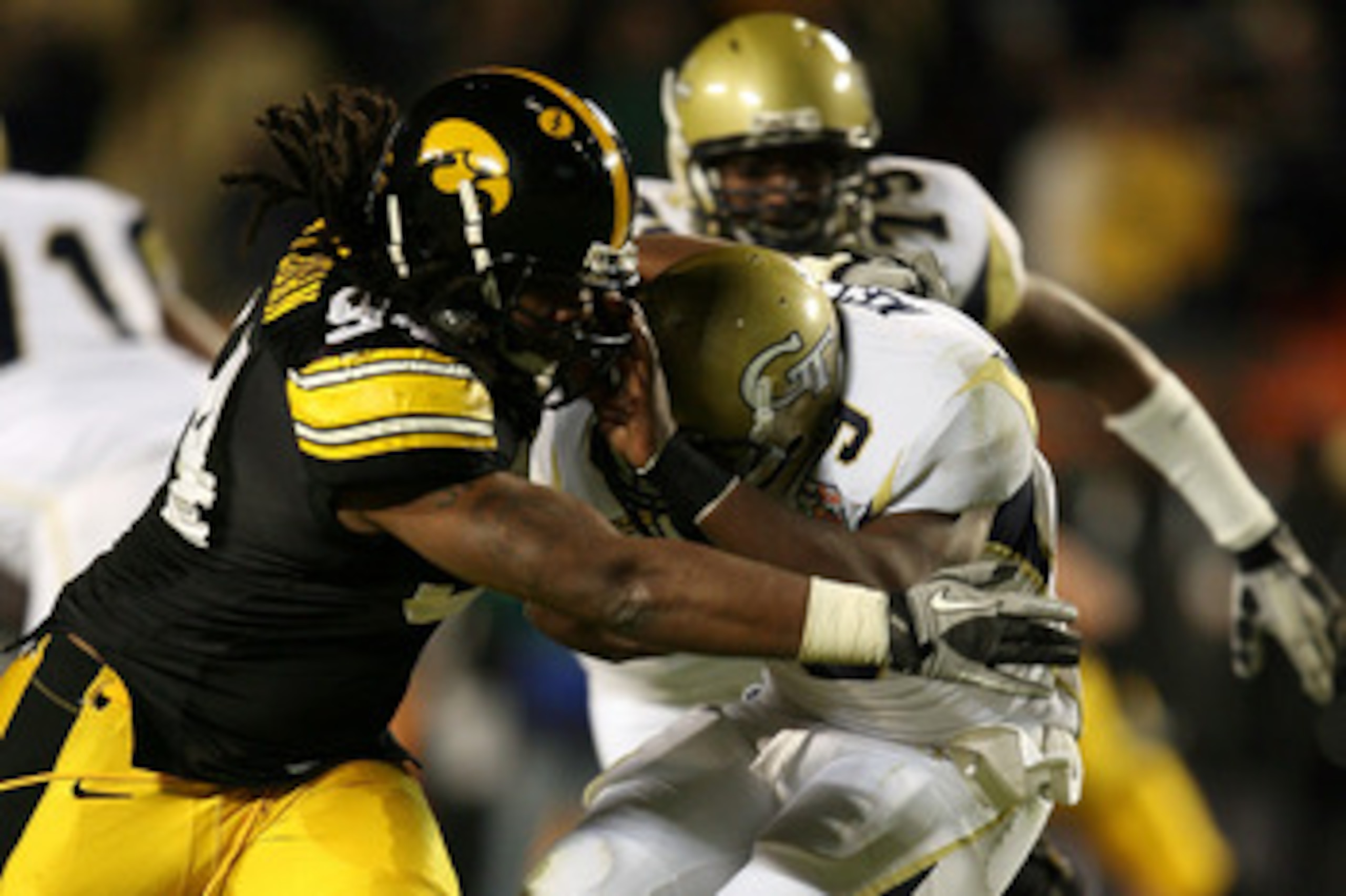 MIAMI GARDENS, FL - JANUARY 05:  Josh Nesbitt #9 of the Georgia Tech Yellow Jackets is bought down by Adrian CLayborn #94 of the Iowa Hawkeyes during the FedEx Orange Bowl at Land Shark Stadium on January 5, 2010 in Miami Gardens, Florida.  (Photo by Doug