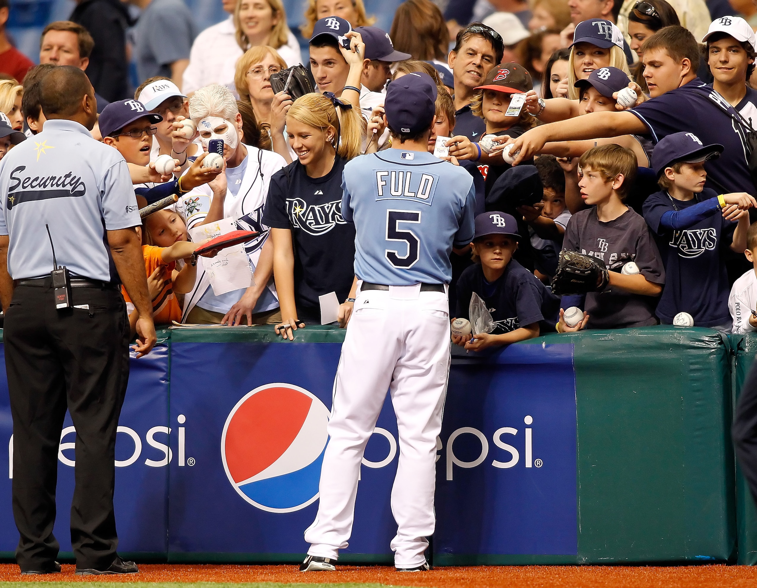 ST. PETERSBURG, FL - APRIL 17:  Outfielder Sam Fuld #5 of the Tampa Bay Rays signs some autographs just before the start of the game against the Minnesota Twins at Tropicana Field on April 17, 2011 in St. Petersburg, Florida.  (Photo by J. Meric/Getty Ima