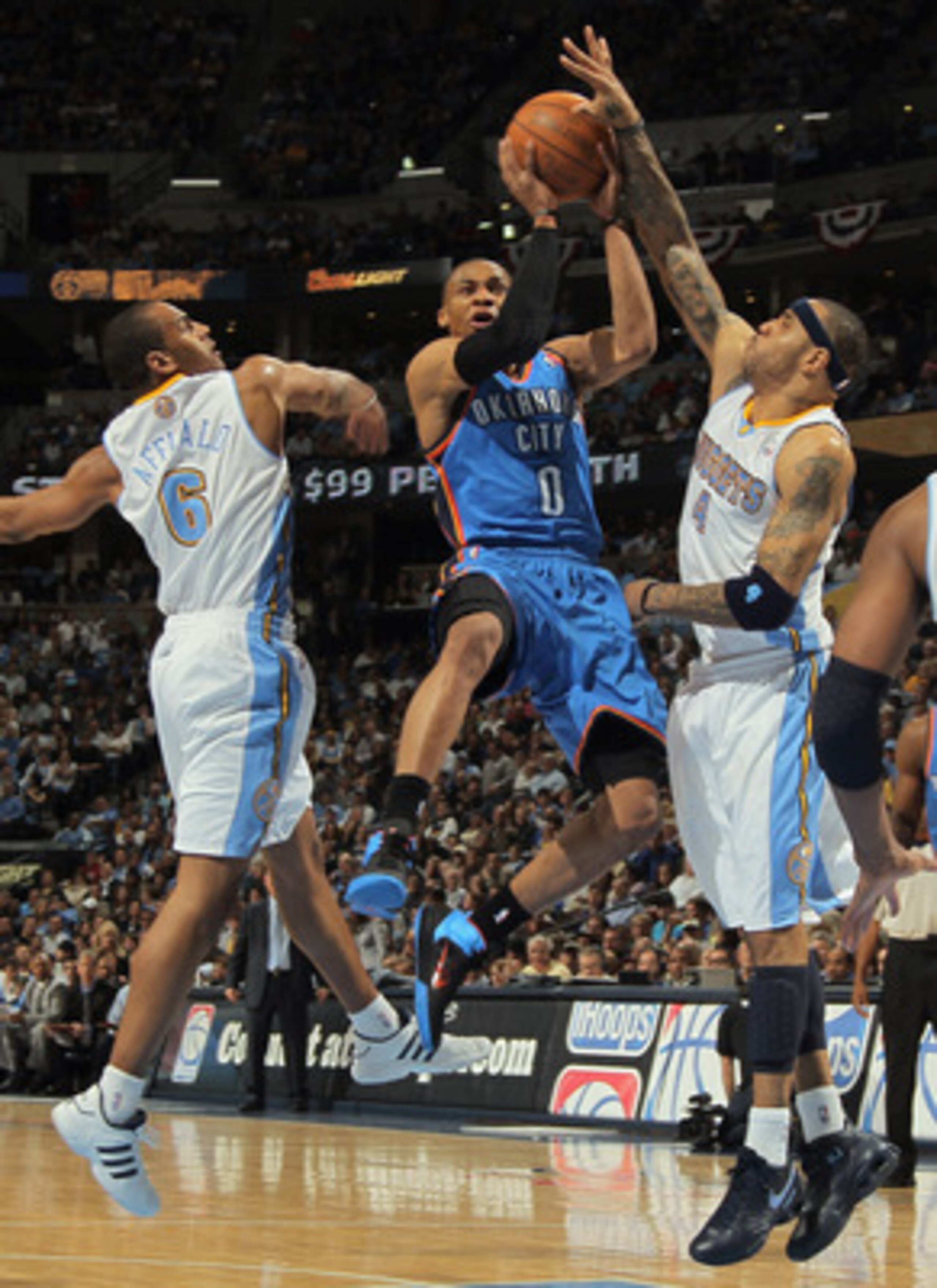 DENVER, CO - APRIL 23:  Russell Westbrook #0 of the Oklahoma City Thunder puts up a shot between Arron Afflalo #6 and Kenyon Martin #4 of the Denver Nuggets in Game Three of the Western Conference Quarterfinals in the 2011 NBA Playoffs on April 23, 2011 a