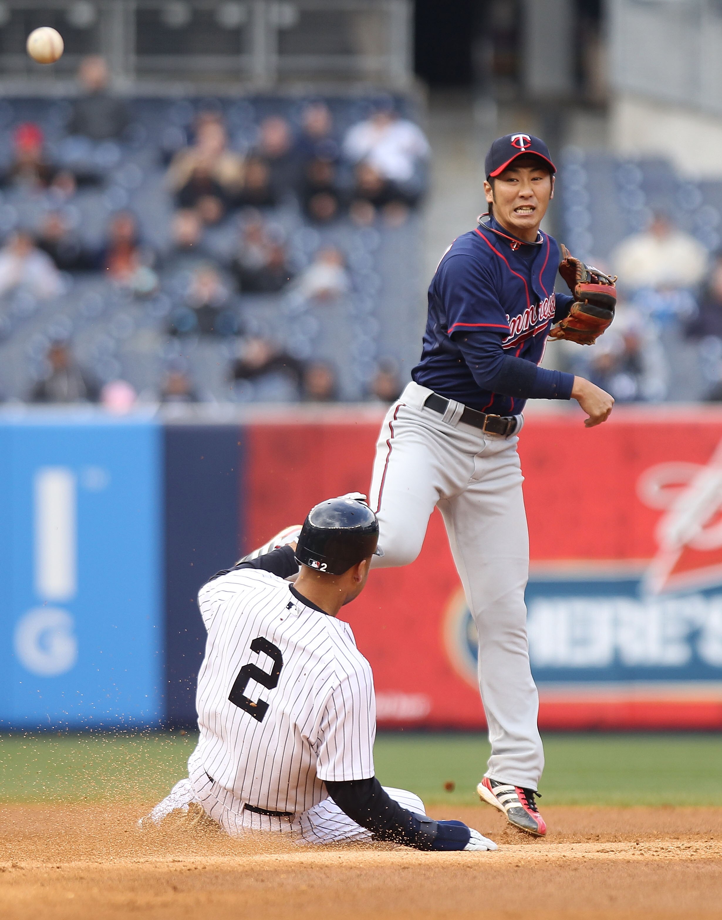 NEW YORK, NY - APRIL 07:  Tsuyoshi Nishioka #1 of the Minnesota Twins fails to turn the double play over Derek Jeter #2 of the New York Yankees at Yankee Stadium on April 7, 2011 in the Bronx borough of New York City.  (Photo by Nick Laham/Getty Images)