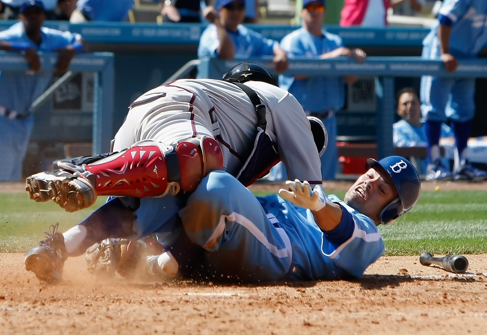 LOS ANGELES, CA - APRIL 21:  Jamey Carroll #14 of the Los Angeles Dodgers is safe at home after colliding with catcher Brian McCann #16 of the Atlanta Braves in the ninth inning at Dodger Stadium on April 21, 2011 in Los Angeles, California. The Dodgers d