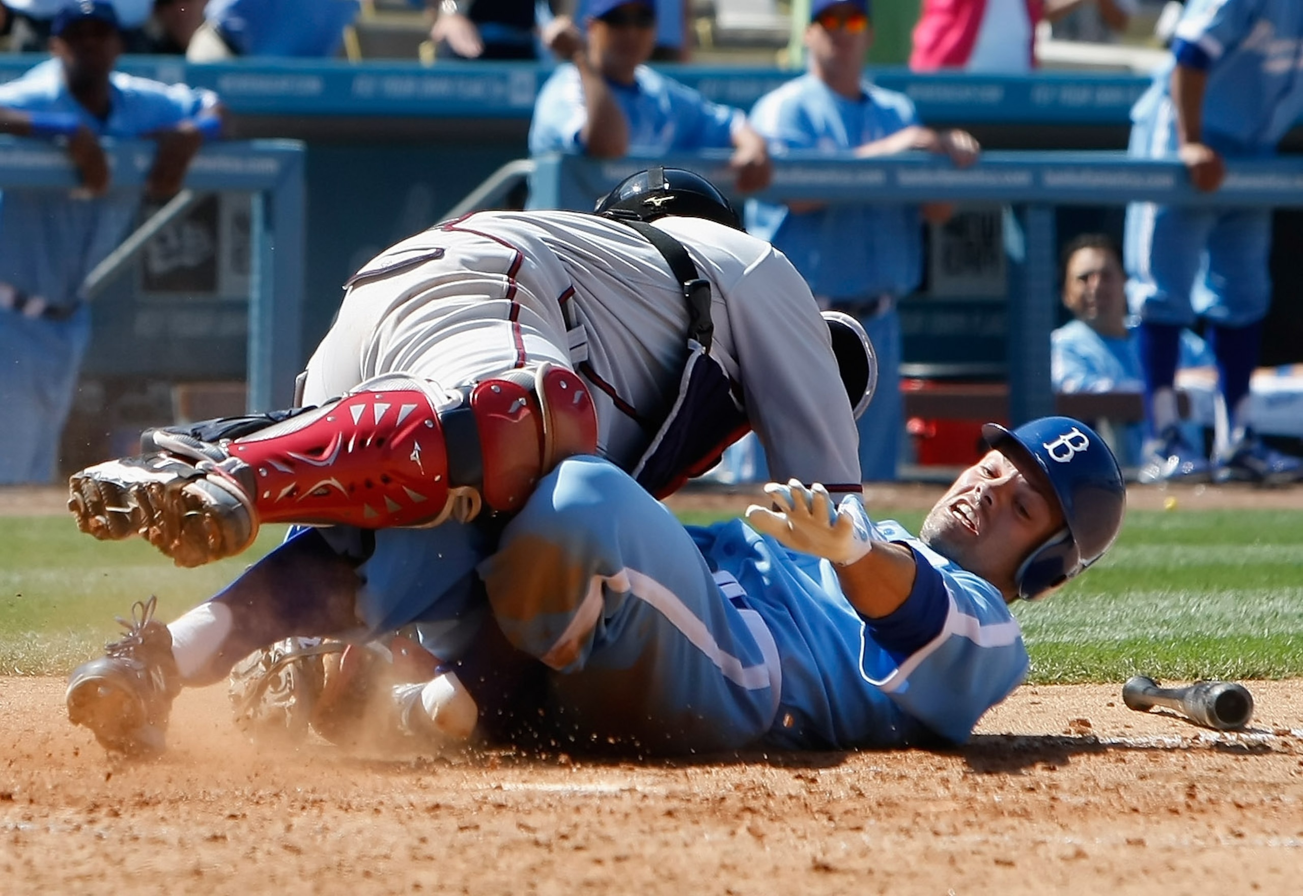 LOS ANGELES, CA - APRIL 21:  Jamey Carroll #14 of the Los Angeles Dodgers is safe at home after colliding with catcher Brian McCann #16 of the Atlanta Braves in the ninth inning at Dodger Stadium on April 21, 2011 in Los Angeles, California. The Dodgers d