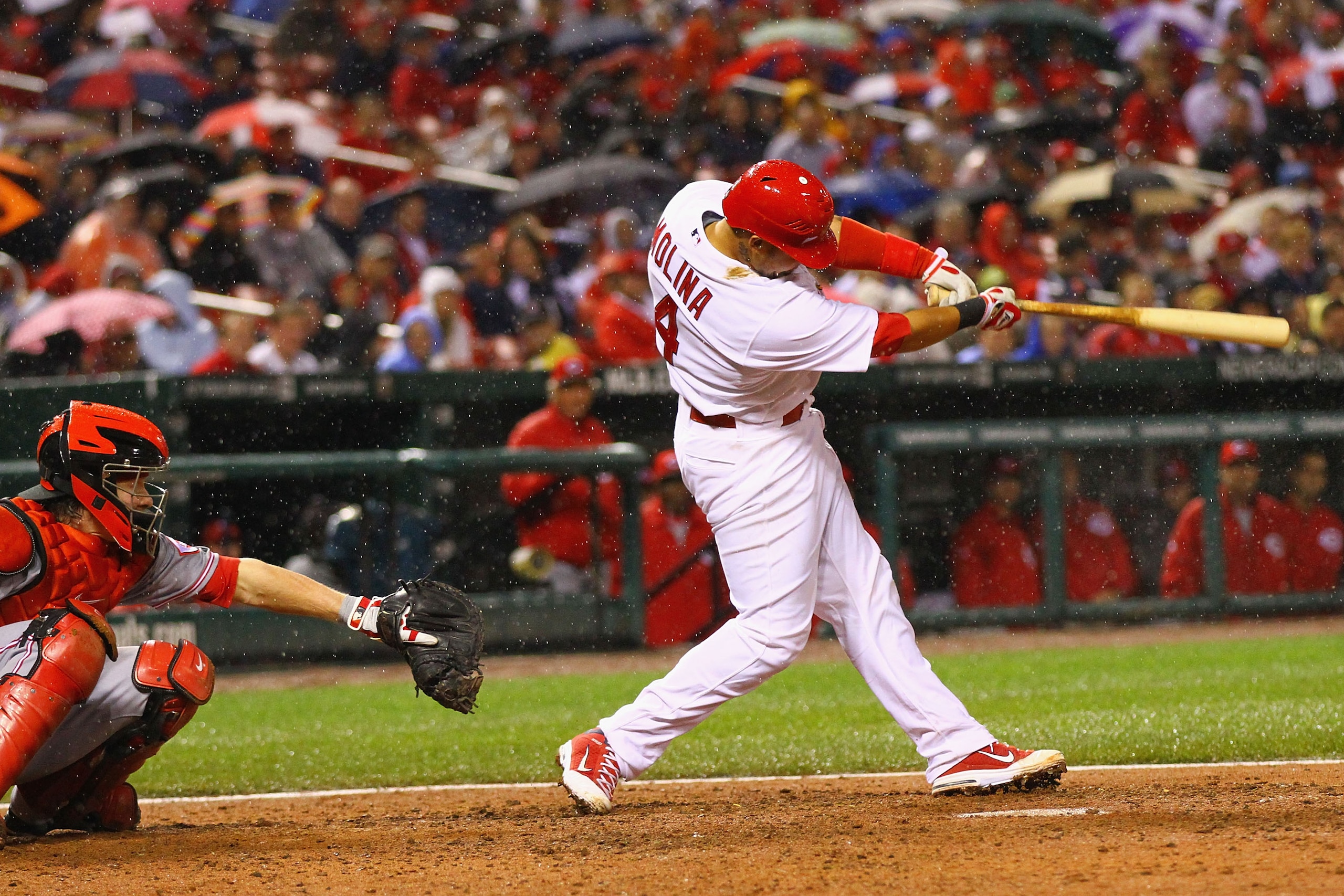 ST. LOUIS, MO - APRIL 24: Yadier Molina #4 of the St. Louis Cardinals hits a three-run home run against the Cincinnati Reds at Busch Stadium on April 24, 2011 in St. Louis, Missouri.  (Photo by Dilip Vishwanat/Getty Images)