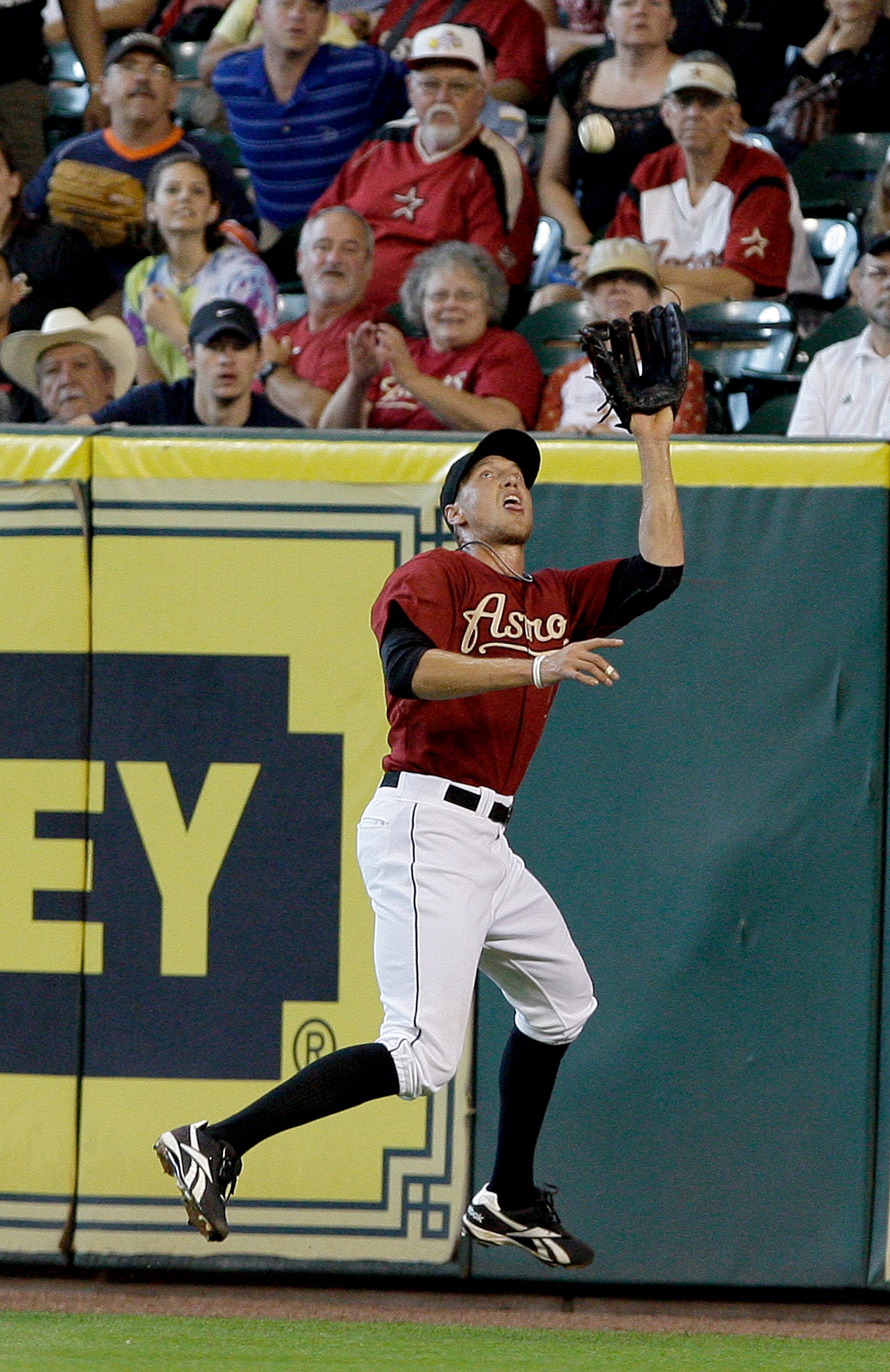 HOUSTON,TX- APRIL 10 : Right fielder Hunter Pence #9  of the Houston Astros catches Wes Helms #18 of the Florida Marlins fly ball on the warning track in the second inning in a MLB  baseball game on April 10, 2011 at Minute Maid Park in Houston, Texas. (P