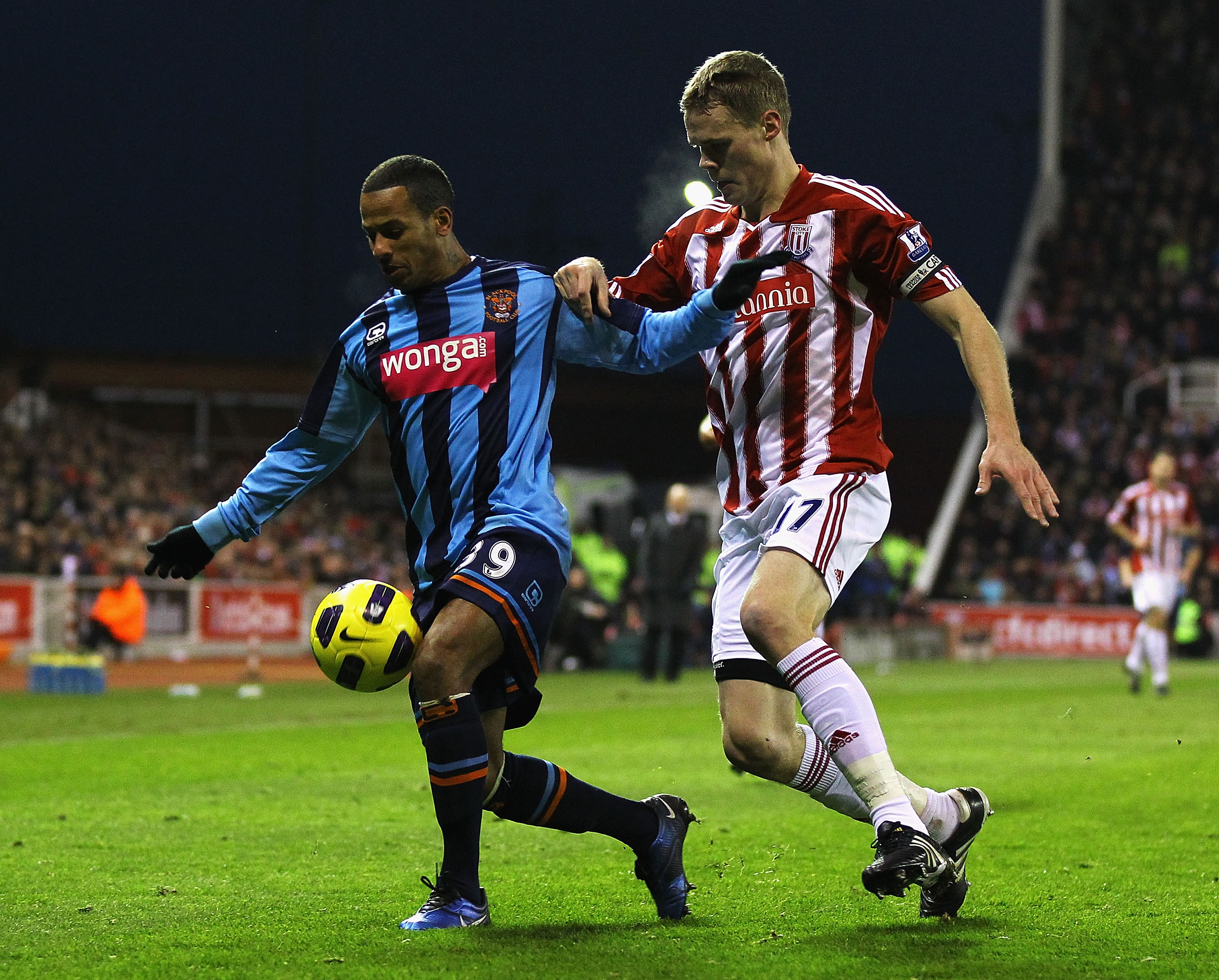 STOKE ON TRENT, ENGLAND - DECEMBER 11:  DJ Campbell of Blackpool holds off Ryan Shawcross of Stoke during the Barclays Premier League match between Stoke City and Blackpool at Britannia Stadium on December 11, 2010 in Stoke on Trent, England.  (Photo by M