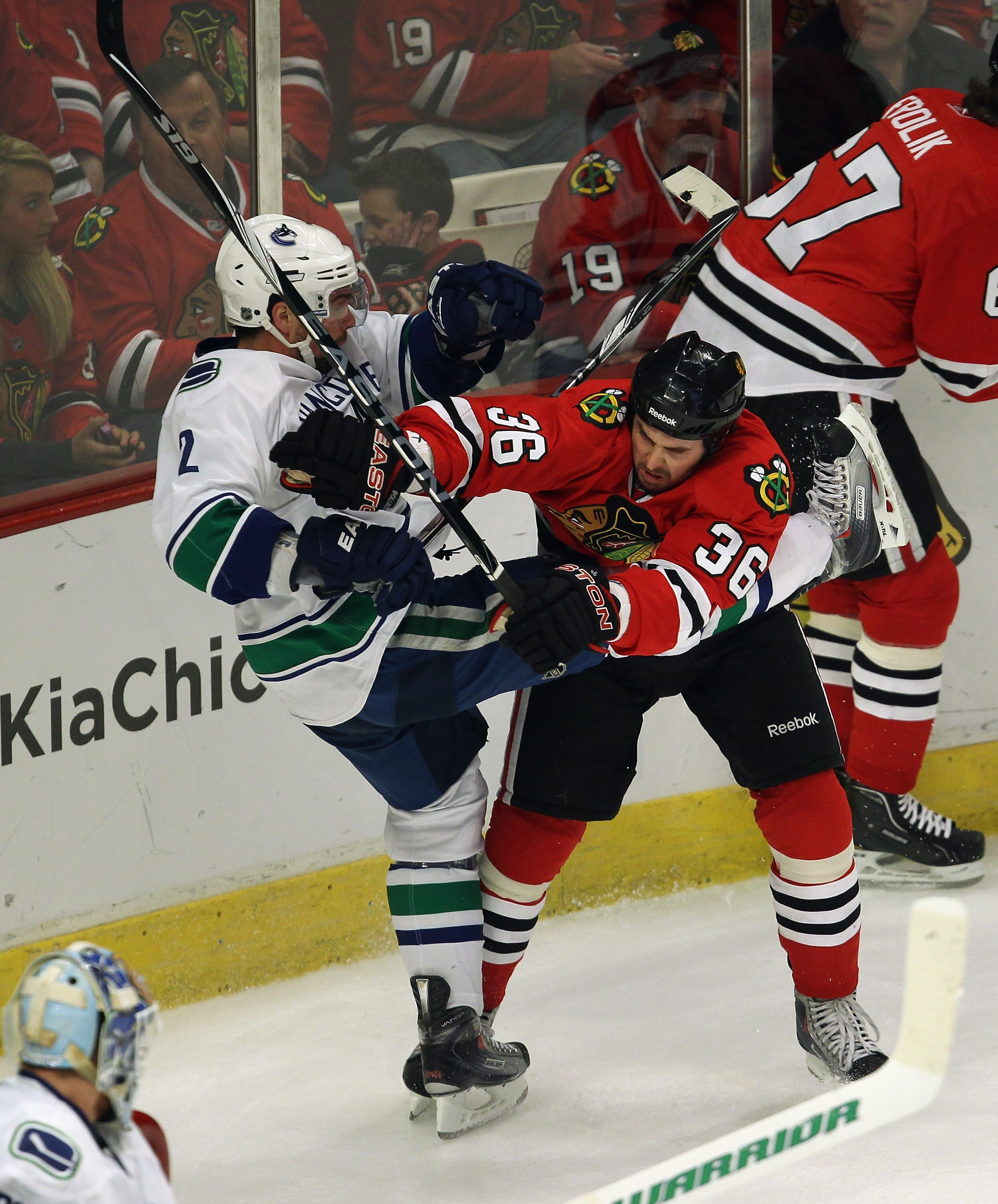 CHICAGO, IL - APRIL 24: Dave Bolland #36 of the Chicago Blackhawks hits Dan Hamhuis #2 of the Vancouver Canucks in Game Six of the Western Conference Quarterfinals during the 2011 NHL Stanley Cup Playoffs at the United Center on April 24, 2011 in Chicago,