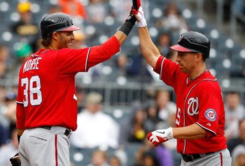 PITTSBURGH - APRIL 24:  Adam LaRoche #25 of the Washington Nationals is congratulated by teammate Michael Morse #38 after scoring a run against  the Pittsburgh Pirates during the game on April 24, 2011 at PNC Park in Pittsburgh, Pennsylvania.  (Photo by J