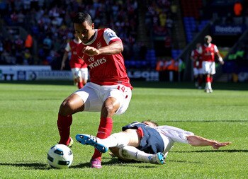 BOLTON, ENGLAND - APRIL 24:  Matt Taylor of Bolton Wanderers tackles Theo Walcott of Arsenal in the penalty area during the Barclays Premier League match between Bolton Wanderers and Arsenal at the Reebok Stadium on April 24, 2011 in Bolton, England.  (Ph
