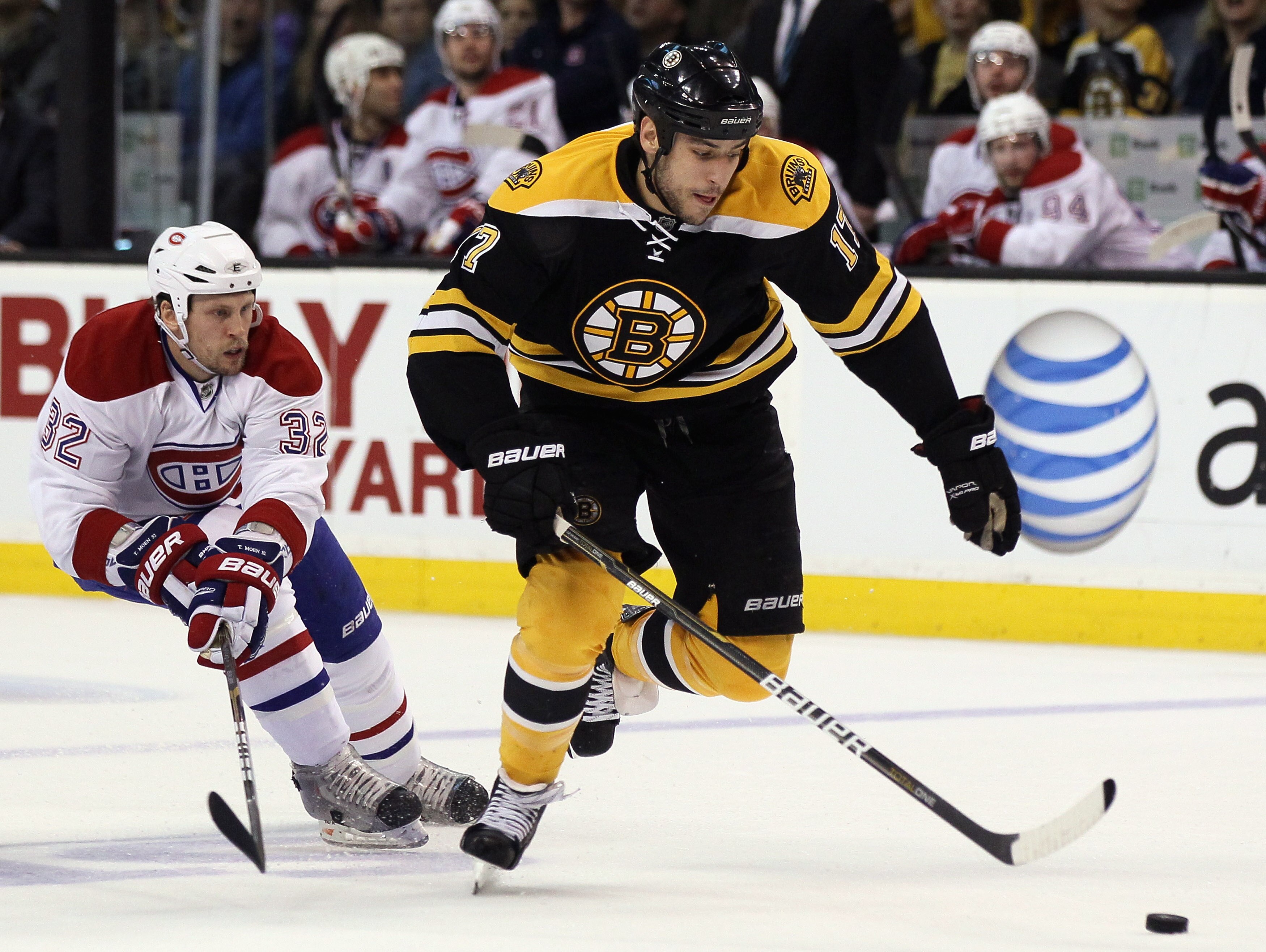 BOSTON, MA - APRIL 23:  Milan Lucic #17 of the Boston Bruins takes the puck as Travis Moen #32 of the Montreal Canadiens defends in Game Five of the Eastern Conference Quarterfinals during the 2011 NHL Stanley Cup Playoffs at TD Garden on April 23, 2011 i
