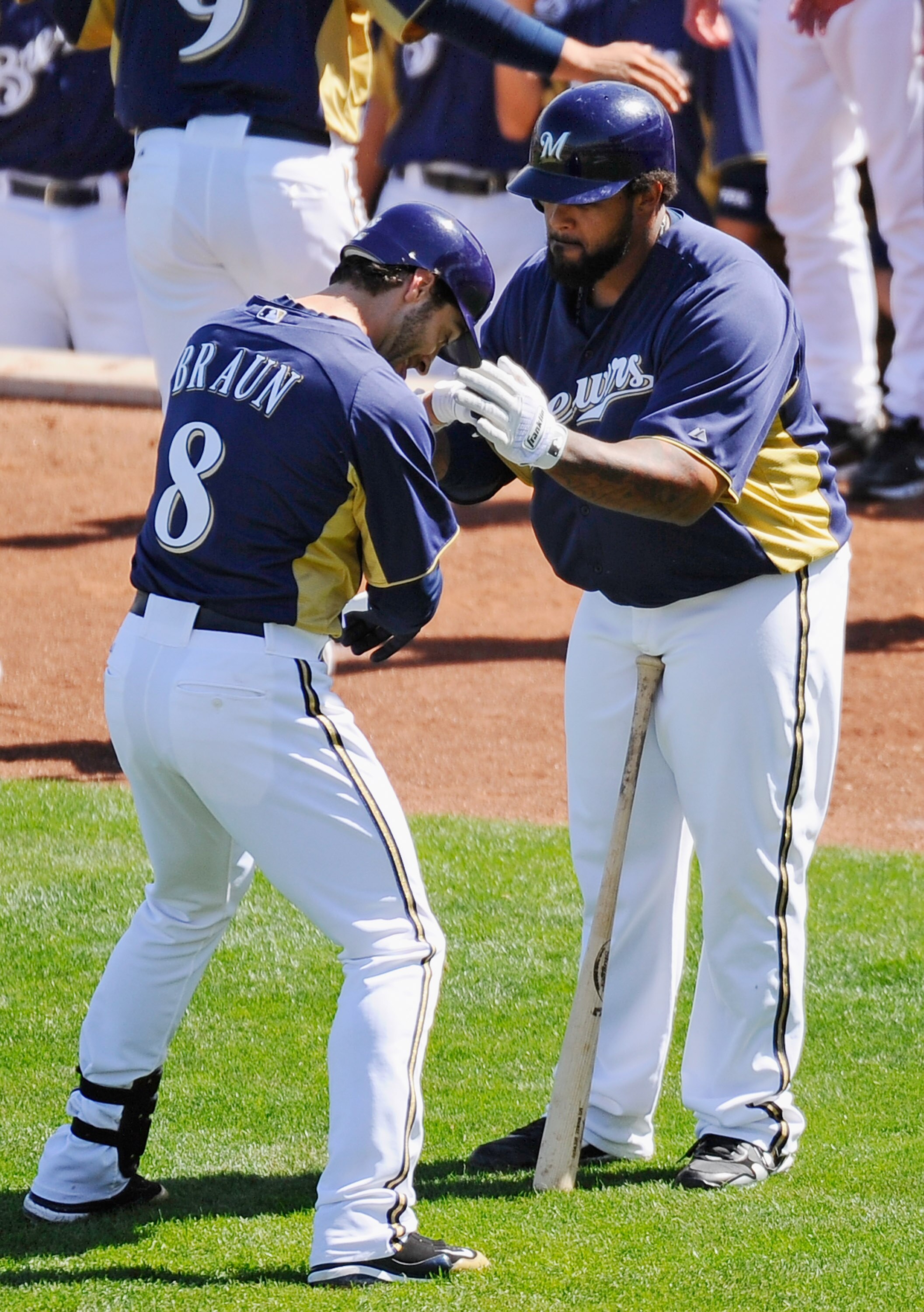 PHOENIX, AZ - MARCH 10:  Ryan Braun #8 of the Milwaukee Brewers is congratulated by teammate Prince Fielder#28 after hitting a three run home run against the Colorado Rockies in the third inning of the spring training baseball game at Maryvale Baseball Pa