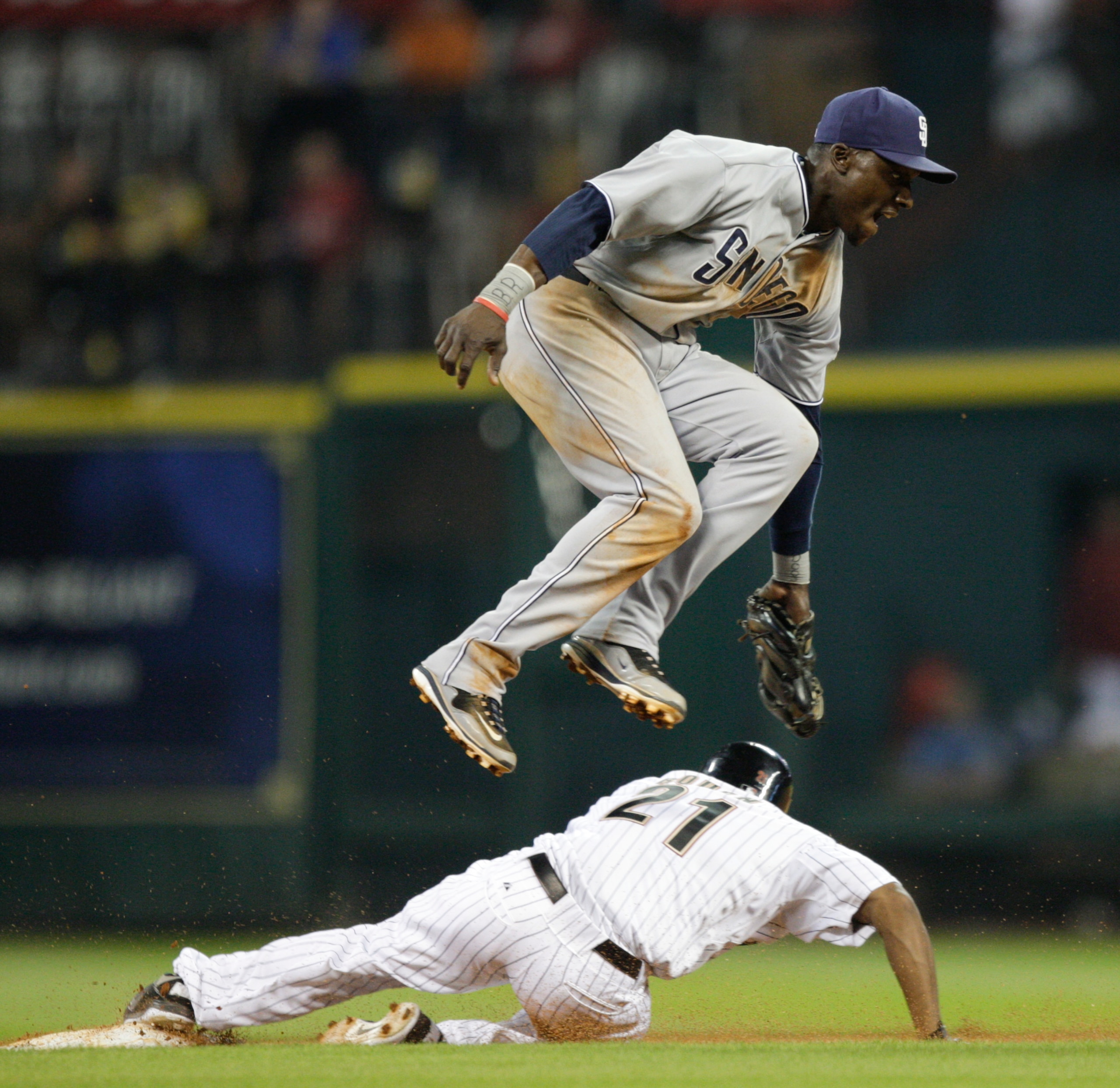 HOUSTON - APRIL 14: Michael Bourn #21 of the Houston Astros slides underneath second baseman Orlando Hudson #1 as he attempts the tag at Minute Maid Park on April 14, 2011 in Houston, Texas. (Photo by Bob Levey/Getty Images) HOUSTON - APRIL 14: Michael Bourn #21 of the Houston Astros slides underneath second baseman Orlando Hudson #1 as he attempts the tag at Minute Maid Park on April 14, 2011 in Houston, Texas. (Photo by Bob Levey/Getty Images)