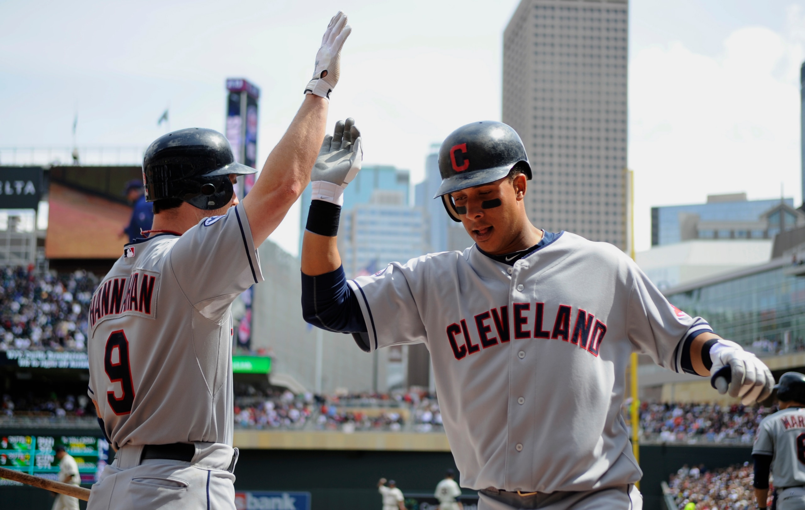 MINNEAPOLIS, MN - APRIL 24: Jack Hannahan #9 and Michael Brantley #23 of the Cleveland Indians celebrate what was thought to be a three-run home run by Brantley against the Cleveland Indians during the third inning of their game on April 24, 2011 at Targe