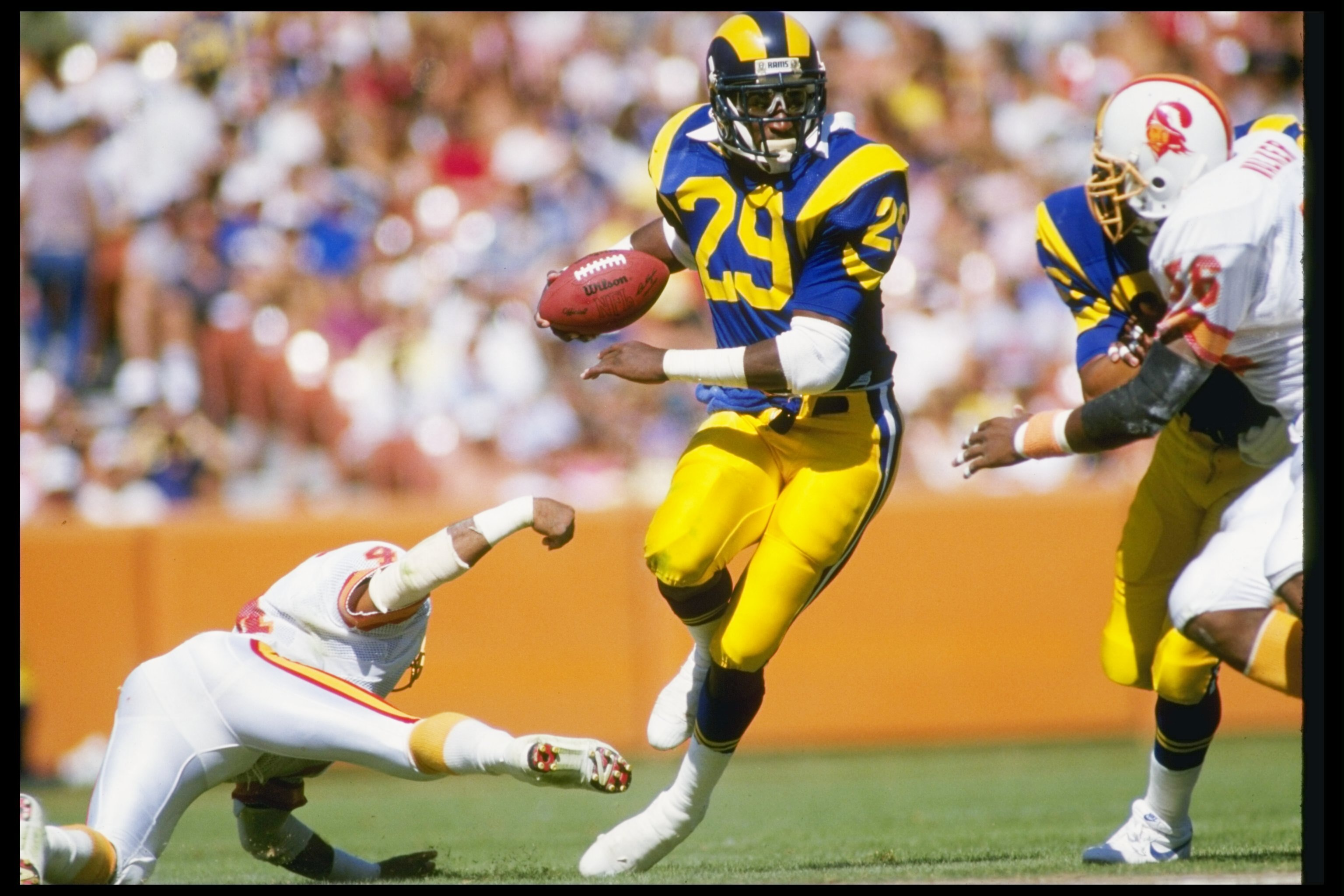 5 Oct 1986:  Running back Eric Dickerson of the Los Angeles Rams moves the ball during a game against the Tampa Bay Buccaneers at Anaheim Stadium in Anaheim, California.  The Rams won the game in overtime, 26-20. Mandatory Credit: Mike Powell  /Allsport