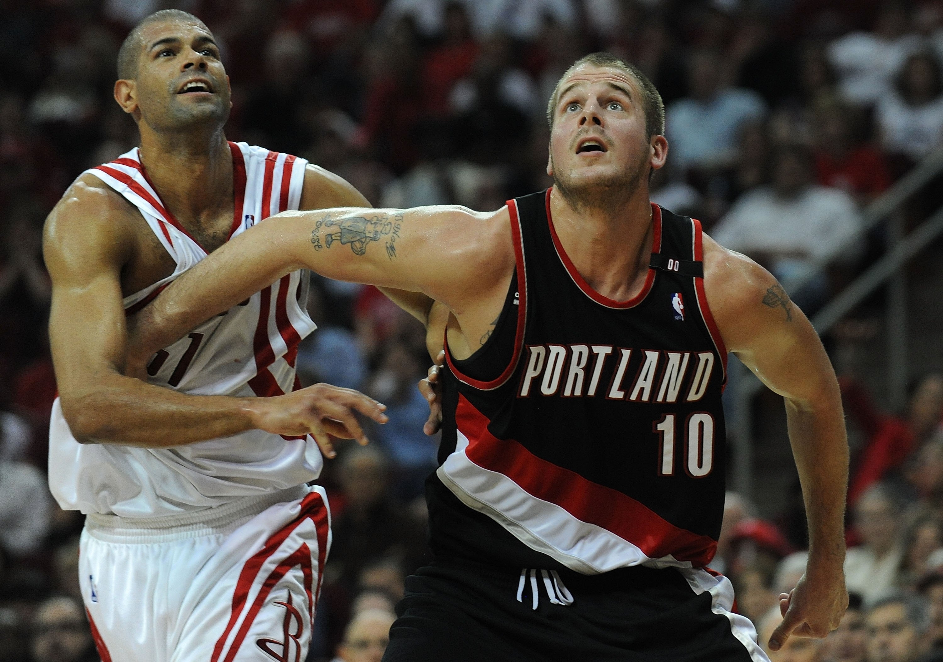 HOUSTON - APRIL 30:  Forward Joel Przybilla #10 of the Portland Trail Blazers and Shane Battier #5 of the Houston Rockets in Game Six of the Western Conference Quarterfinals during the 2009 NBA Playoffs at Toyota Center on April 30, 2009 in Houston, Texas