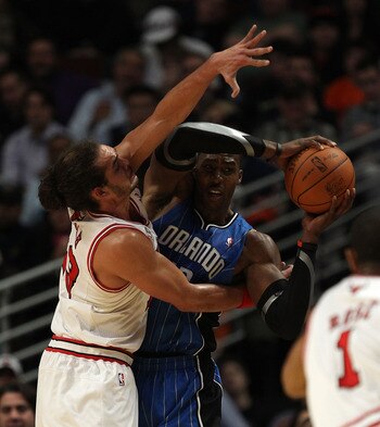 CHICAGO, IL - DECEMBER 01: Dwight Howard #12 of the Orlando Magic looks to pass under pressure from Joakim Noah #13 of the Chicago Bulls at the United Center on December 1, 2010 in Chicago, Illinois. The Magic defeated the Bulls 107-78. NOTE TO USER: User