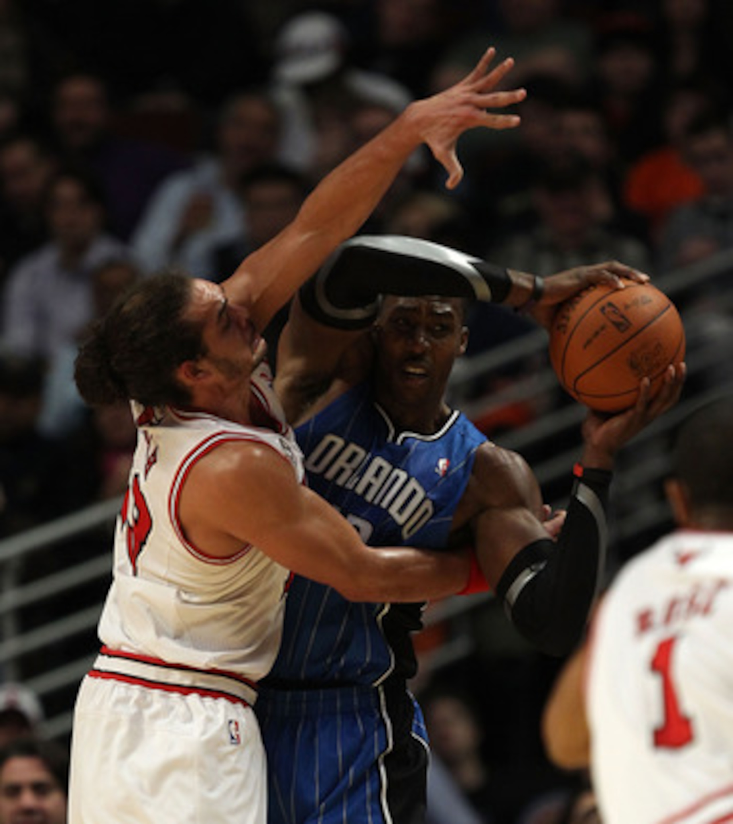 CHICAGO, IL - DECEMBER 01: Dwight Howard #12 of the Orlando Magic looks to pass under pressure from Joakim Noah #13 of the Chicago Bulls at the United Center on December 1, 2010 in Chicago, Illinois. The Magic defeated the Bulls 107-78. NOTE TO USER: User